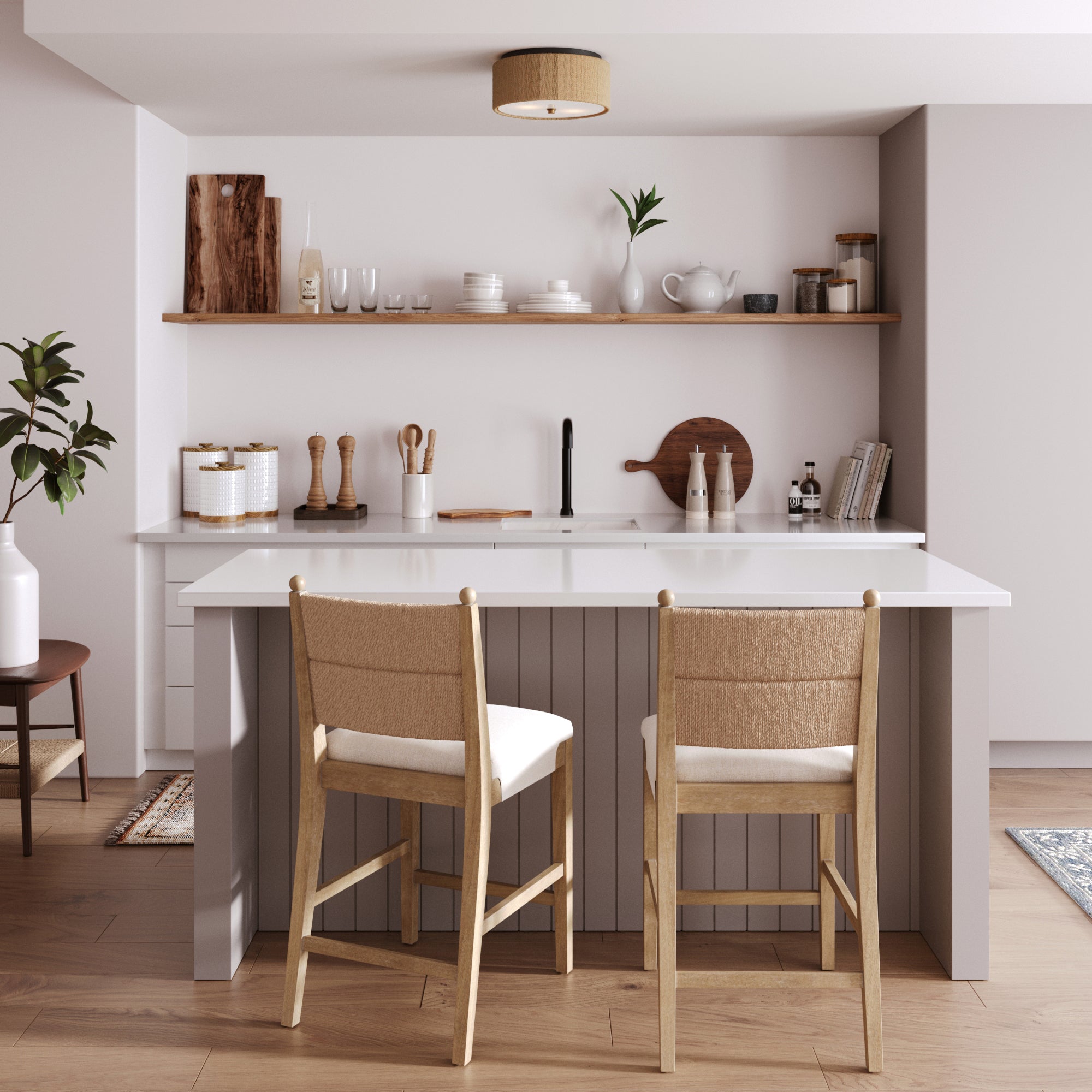 Modern kitchen with a white island, two wooden chairs with cushions, open shelving displaying dishes and decor, light wood flooring, and neutral-toned walls. A potted plant sits on the left side of the counter.