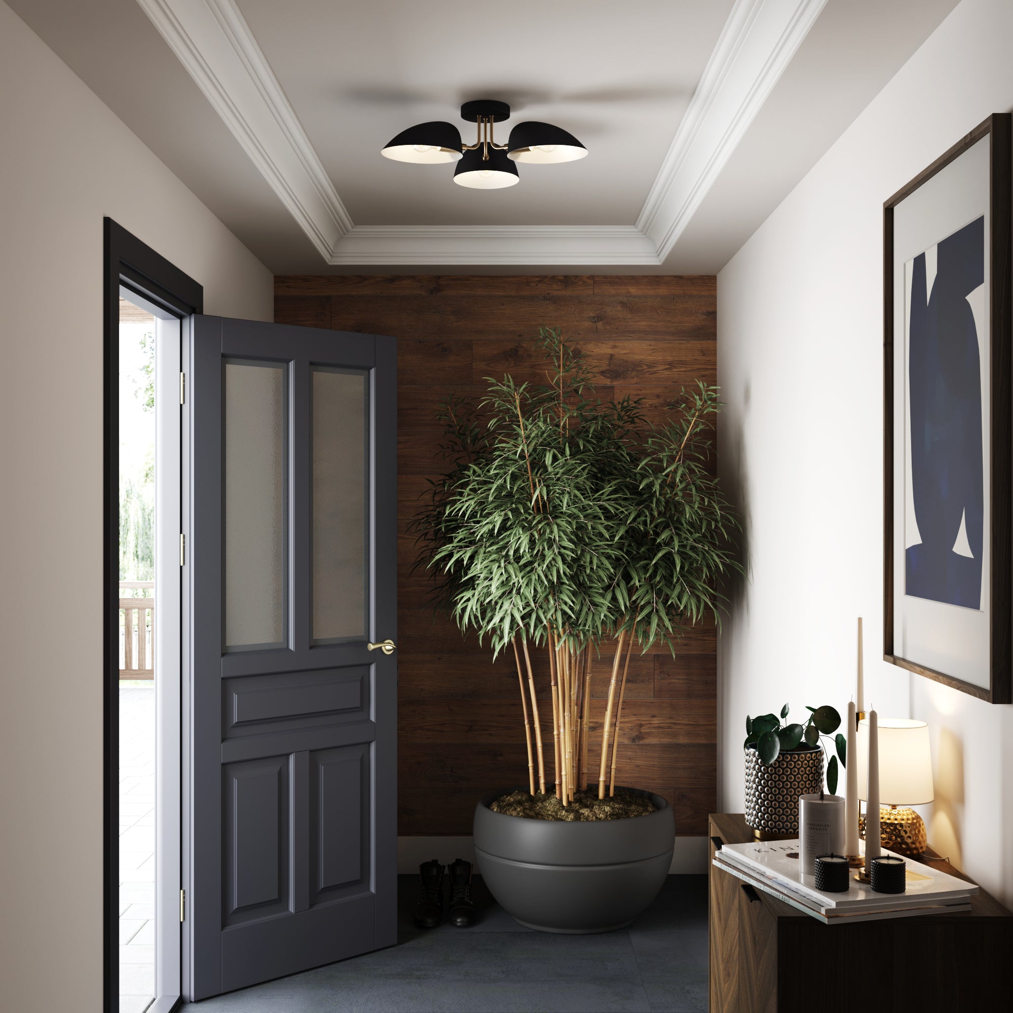 A modern entryway with a gray door, potted tall plant against a wooden accent wall, ceiling light, framed abstract art, and a small table with decorative items and a lit lamp.