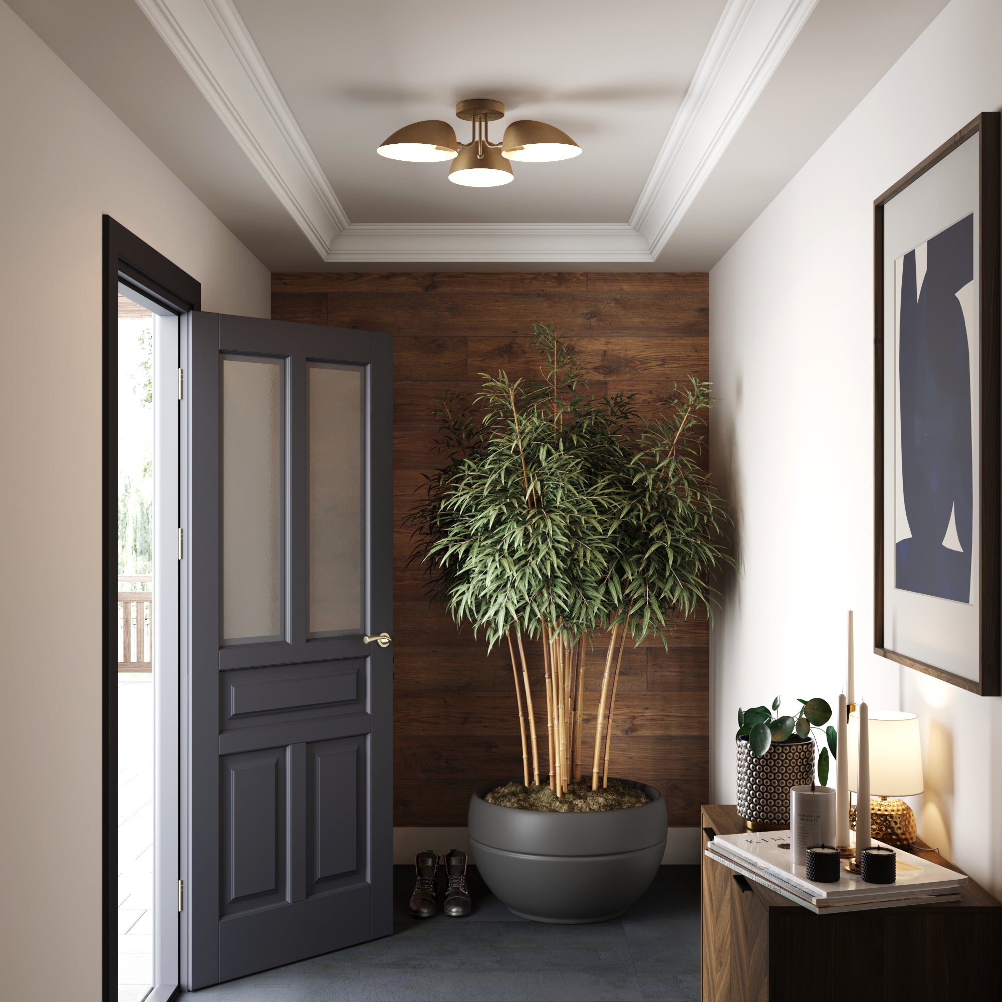 A modern hallway with a dark door partially open, a large potted plant against a wooden accent wall, a side table with decor items, framed artwork, and a ceiling light fixture.