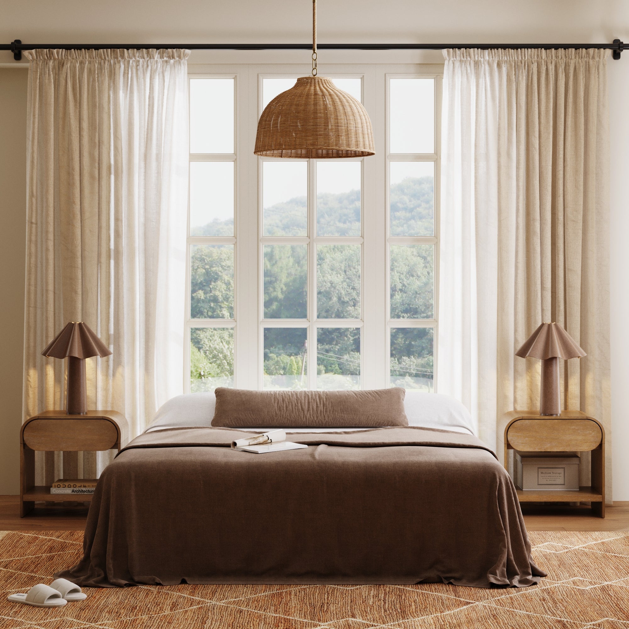 A cozy bedroom with a large window, sheer white curtains, a rattan pendant lamp, a bed with brown bedding, two books, and matching nightstands with brown lamps. Lush greenery is visible outside.