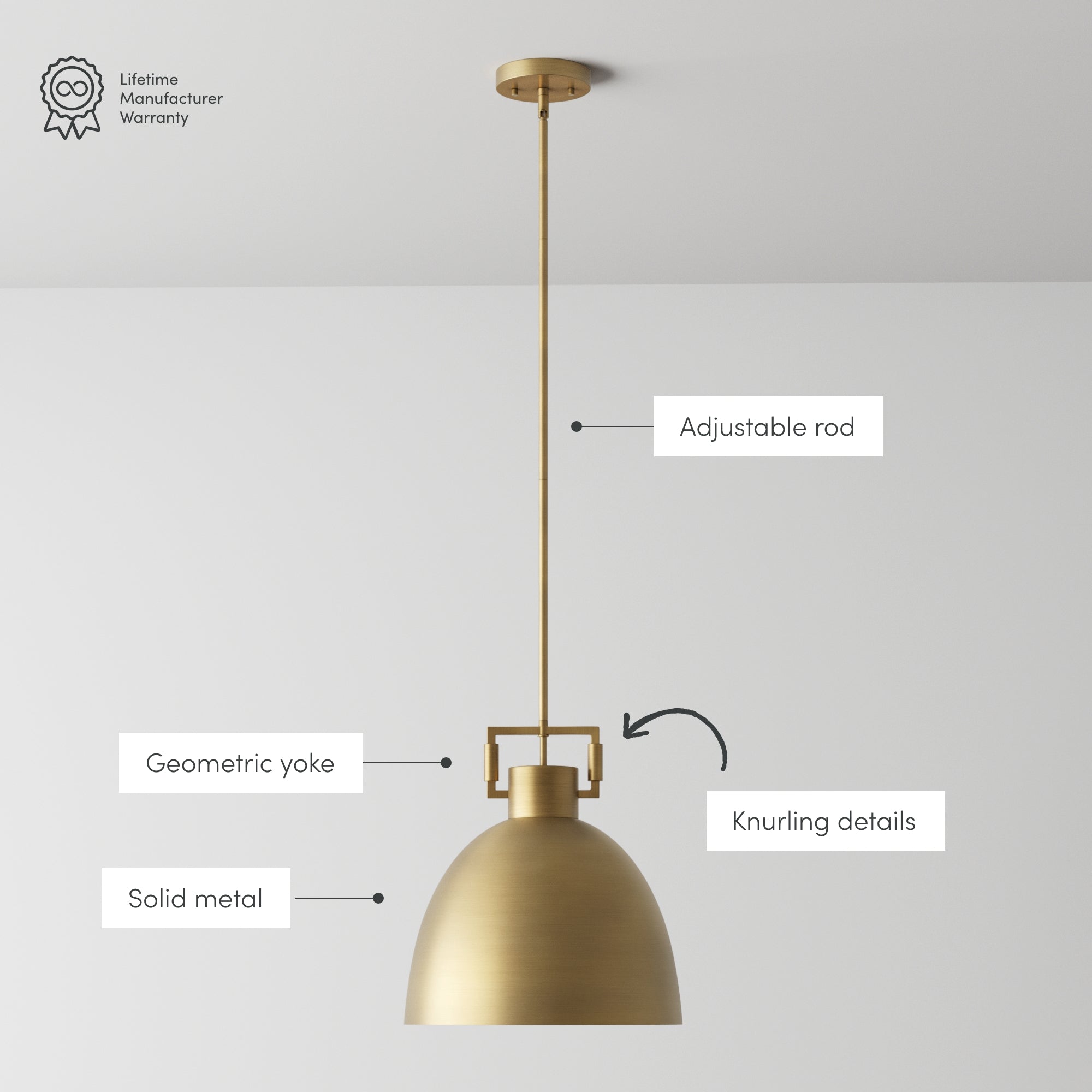 A brass pendant light hangs from the ceiling with labeled features: an adjustable rod, geometric yoke, knurling details, and solid metal construction. A Lifetime Manufacturer Warranty icon appears in the top left corner.