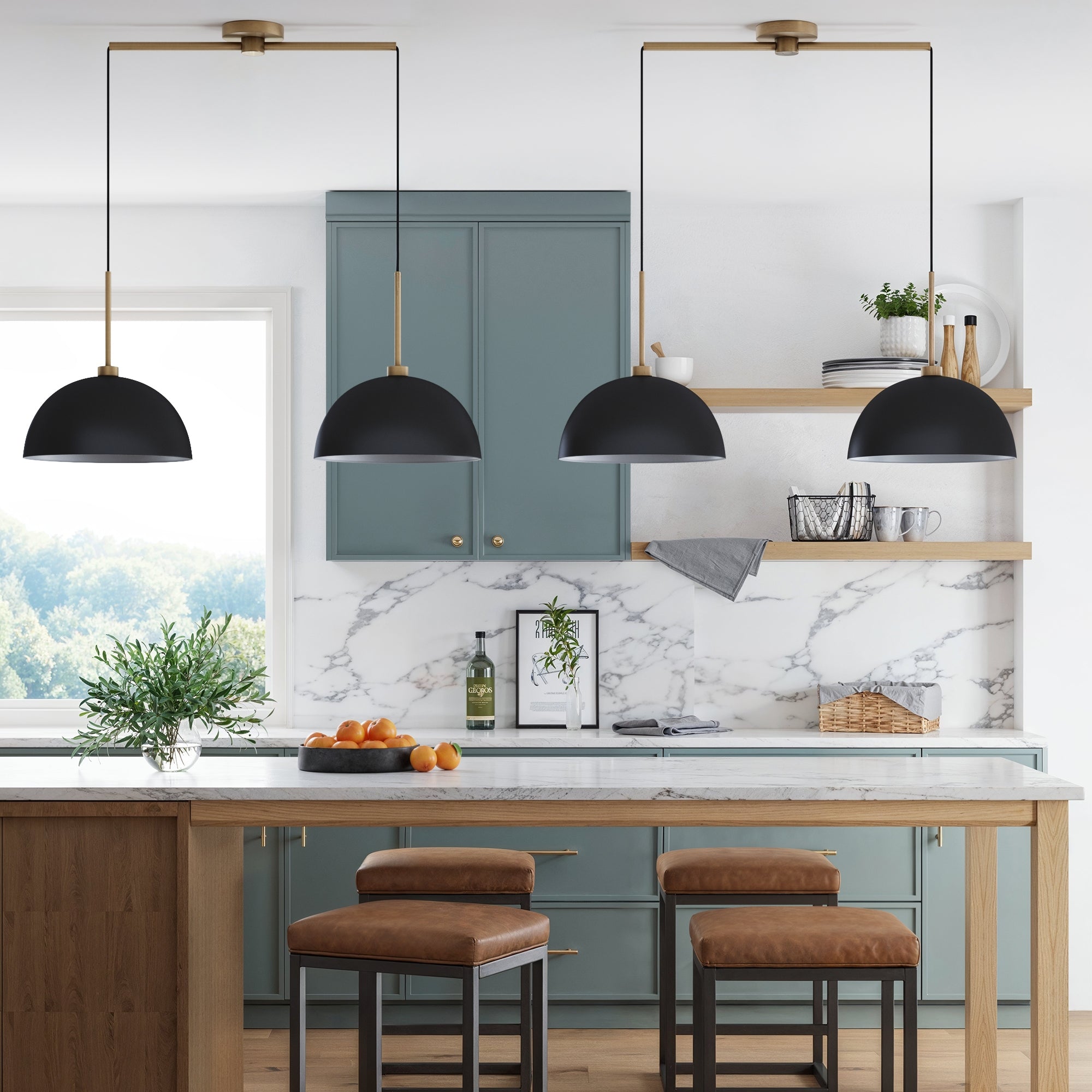 Modern kitchen with blue cabinets, marble backsplash, wood island, tan leather stools, black pendant lights, open wooden shelves with decor, and a bowl of oranges on the counter. Large window with greenery outside.