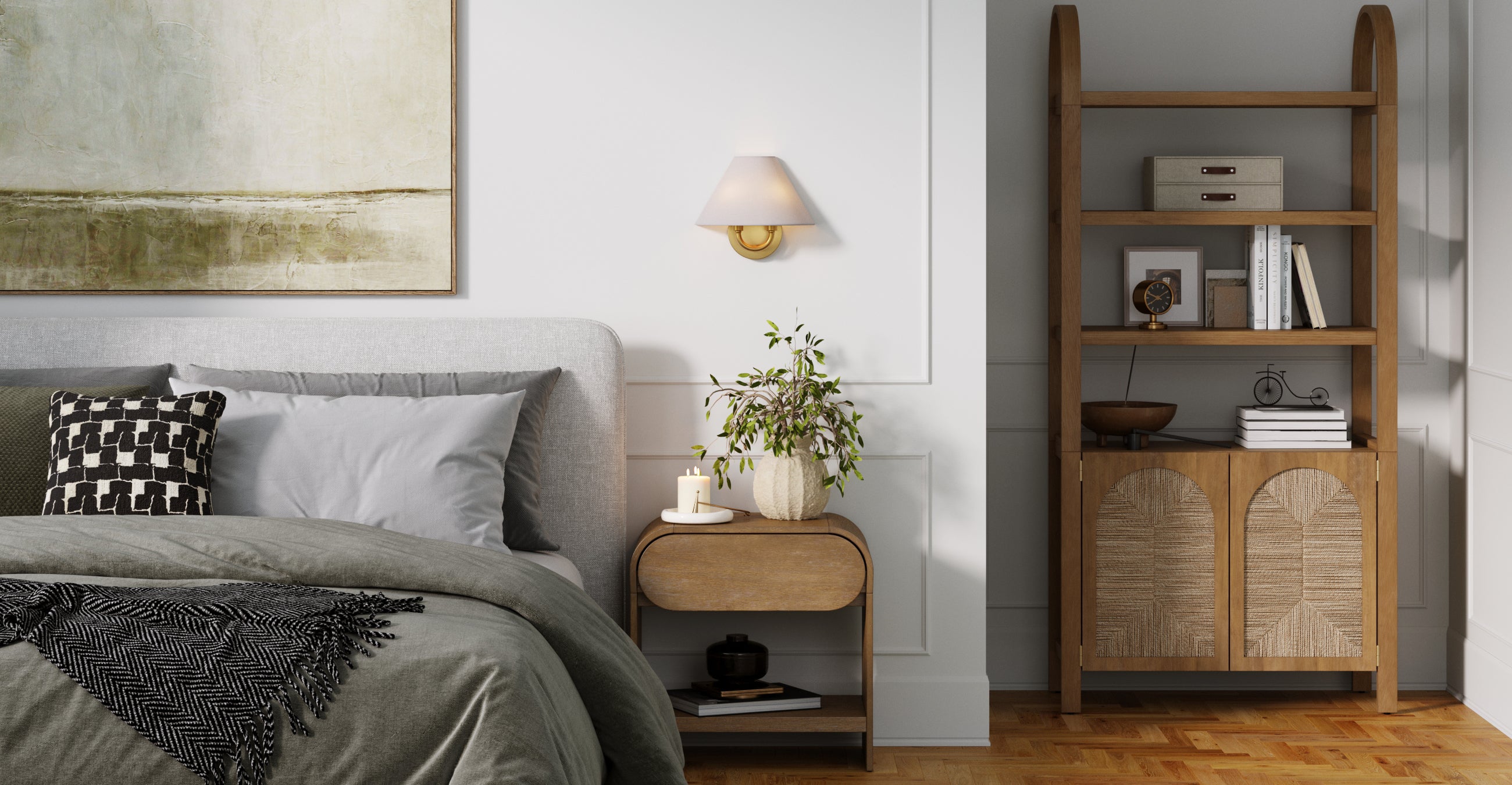 A modern bedroom with a gray bed, black and white pillow, small wooden nightstand with a plant and book, a wall sconce, a large abstract painting, and a wooden shelving unit with decor and books.