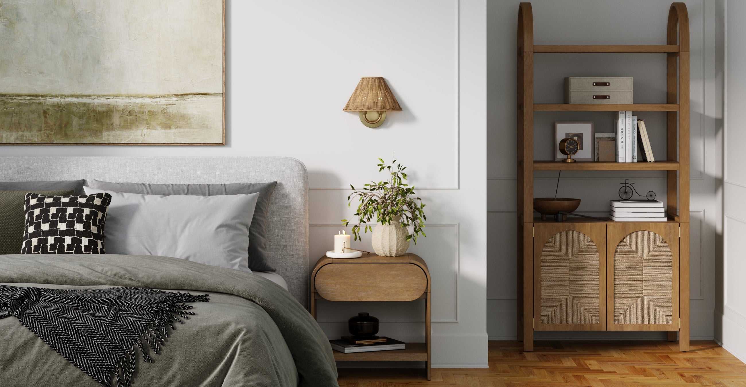 A cozy bedroom with a gray upholstered bed, patterned pillows, and a wooden nightstand with a potted plant. A bookshelf with decor items and boxes stands nearby. Light wood accents and soft lighting create a calm atmosphere.
