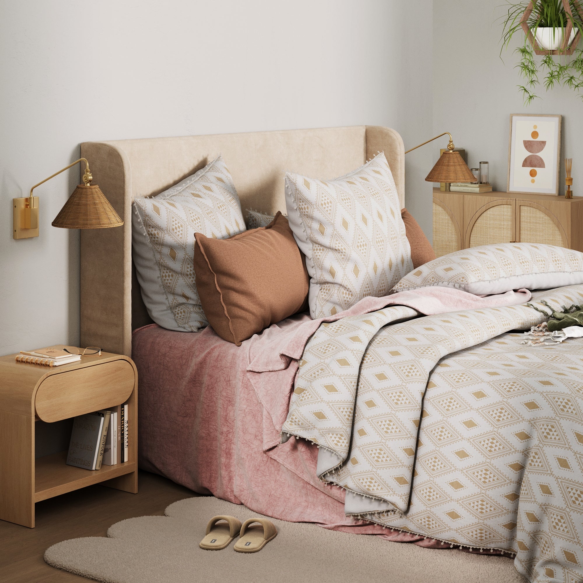 Cozy bedroom with a beige upholstered headboard, patterned pillows, a pink blanket, wooden nightstands, Nathan James Rattan Shade Adjustable Plug In Wall Lights (set of 2), framed art, potted plants, and slippers on a scalloped rug.