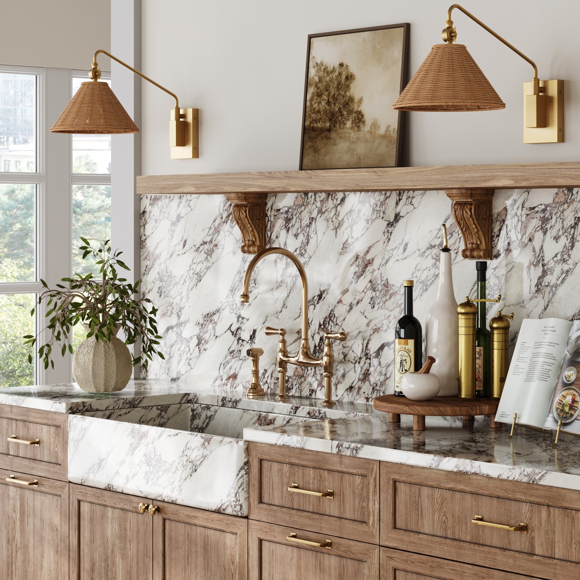 A stylish kitchen with wood cabinets, gold hardware, marble backsplash and sink, brass faucet, a potted plant, olive oil bottles on a tray, an open cookbook and framed art on the shelf, plus the Nathan James Rattan Shade Adjustable Plug-In Wall Light.