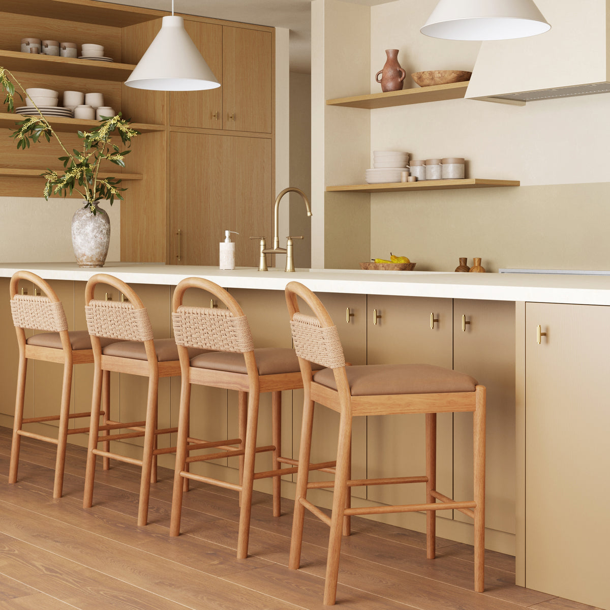 Four Modern Seagrass & Faux Suede Counter Stool Warm Pine stools with rubberwood frames arranged at a kitchen island.