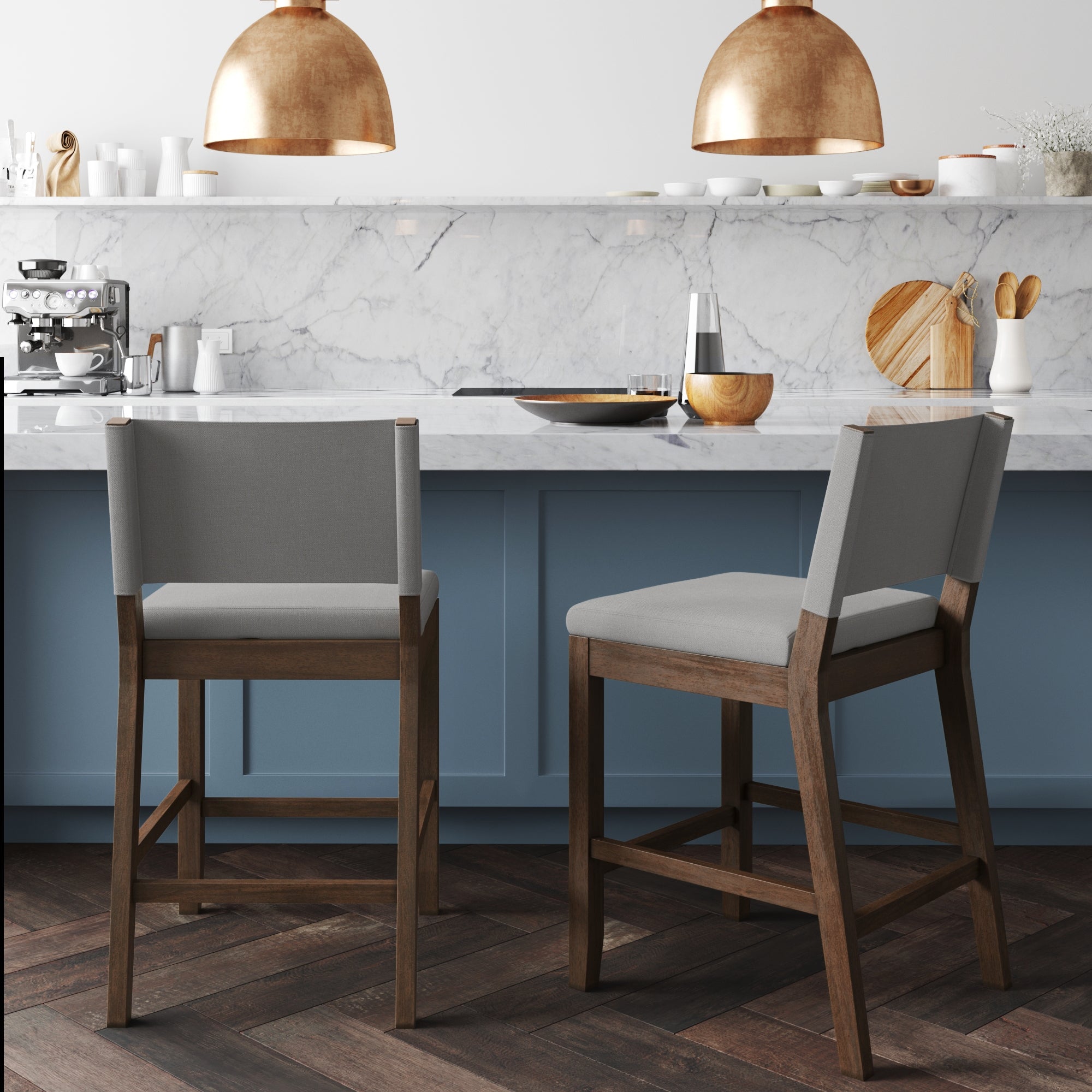 The Nathan James Wood Counter Height Bar Stools in dark brown and gray (set of 2) add an inviting modern farmhouse touch to a marble kitchen counter with blue cabinets and copper pendant lights.