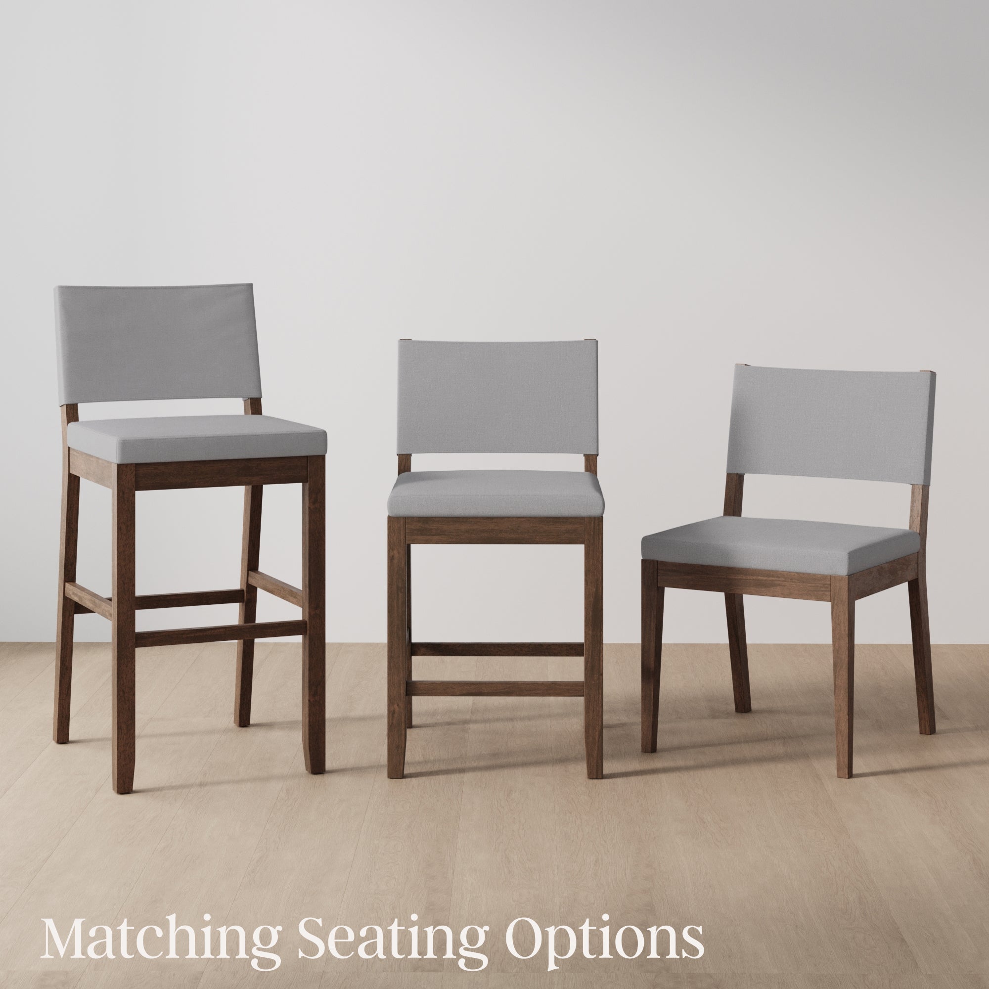 Three wooden chairs with light gray cushions are arranged in a row on a light wood floor. The chairs vary in height, including a bar stool, a counter-height chair, and a standard dining chair. Text reads Matching Seating Options.
