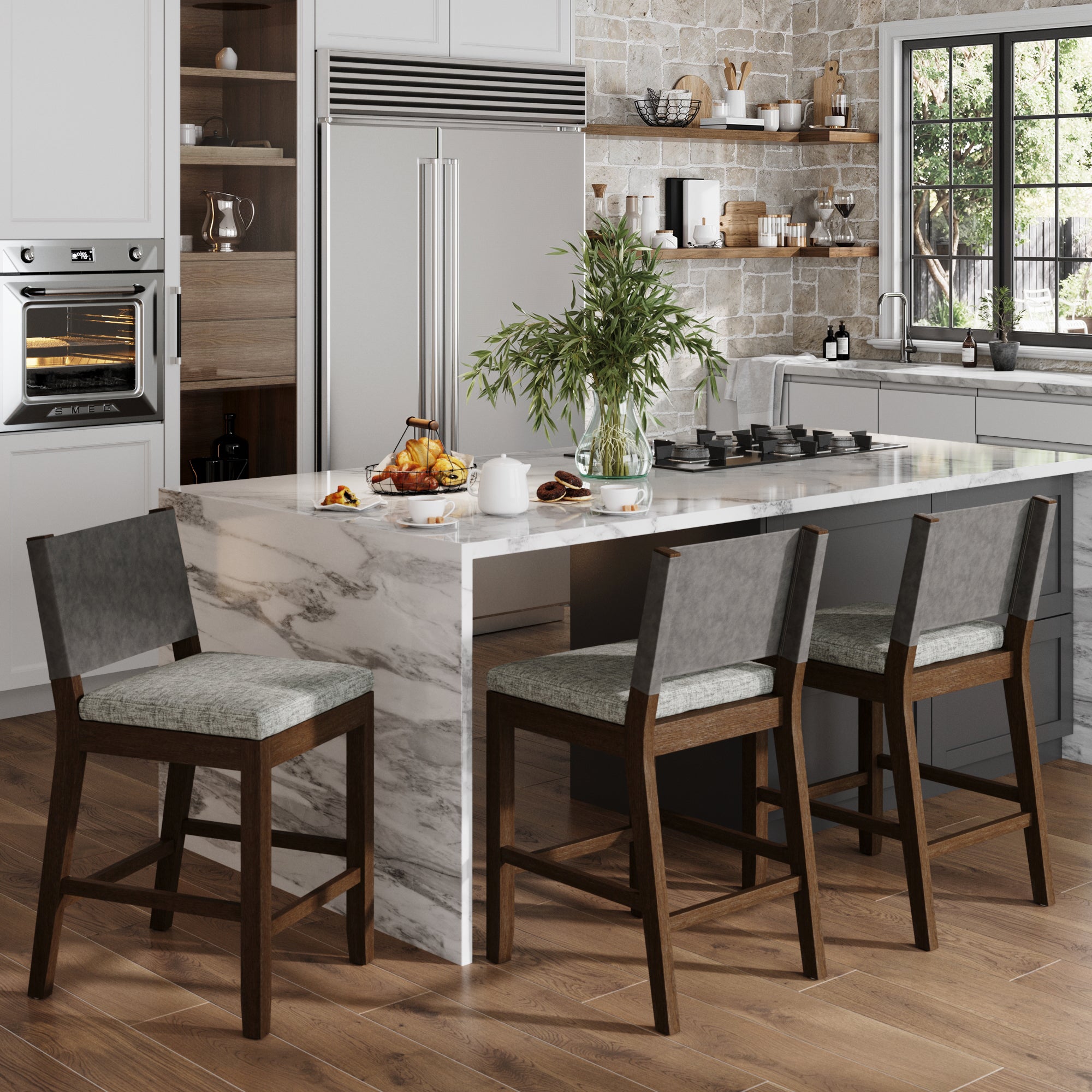 Modern kitchen with a marble island featuring Nathan James Wood Counter Height Bar Stools in Dark Brown/Ivory (Set of 3), built-in oven, large fridge, open shelves with dishes, and a window overlooking greenery. Island is set for breakfast.