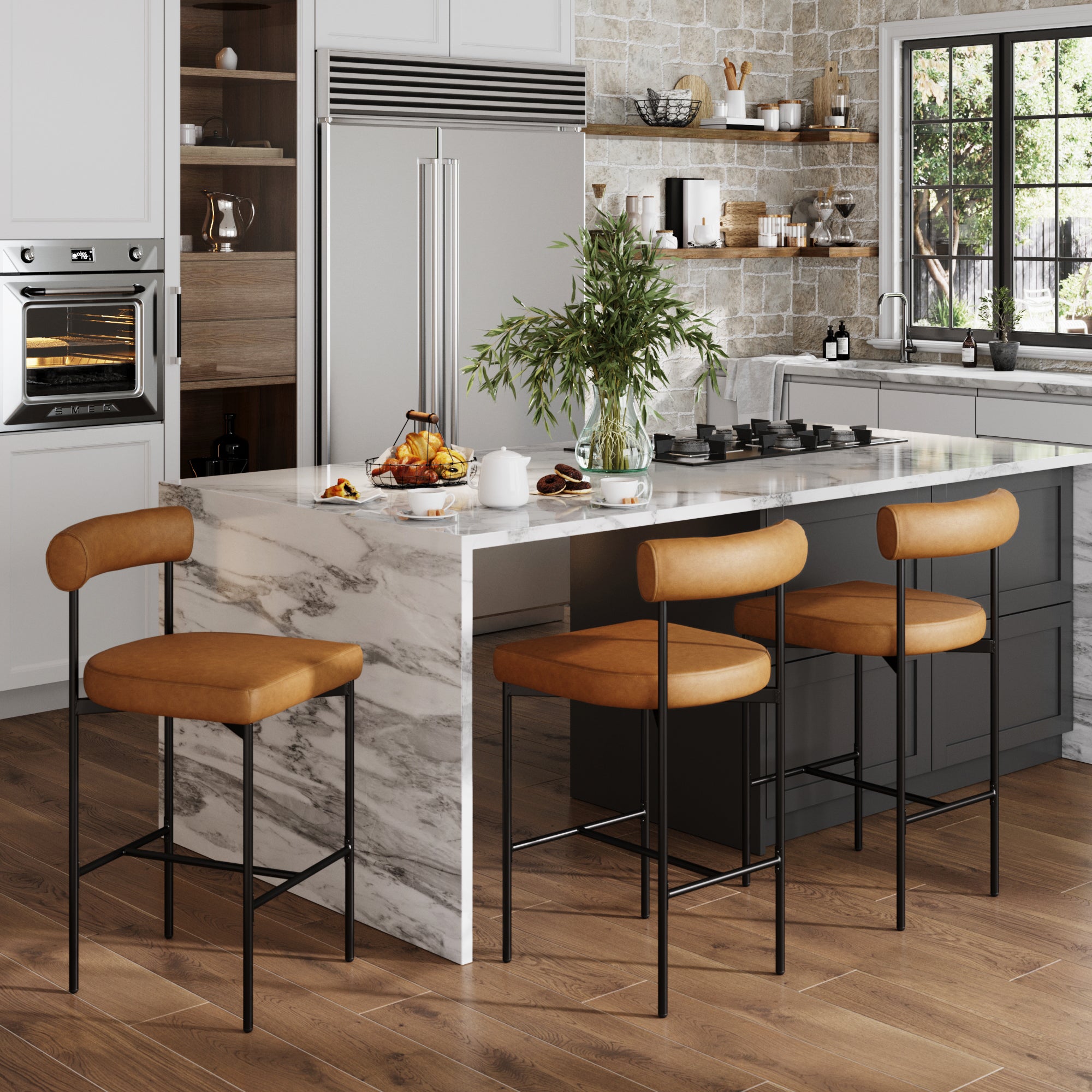 Modern kitchen with a marble island, three Nathan James Faux Leather Counter Height Bar Stools in brown, wood flooring, stainless steel appliances, a built-in oven, open shelves with dishes, and a window letting in natural light.