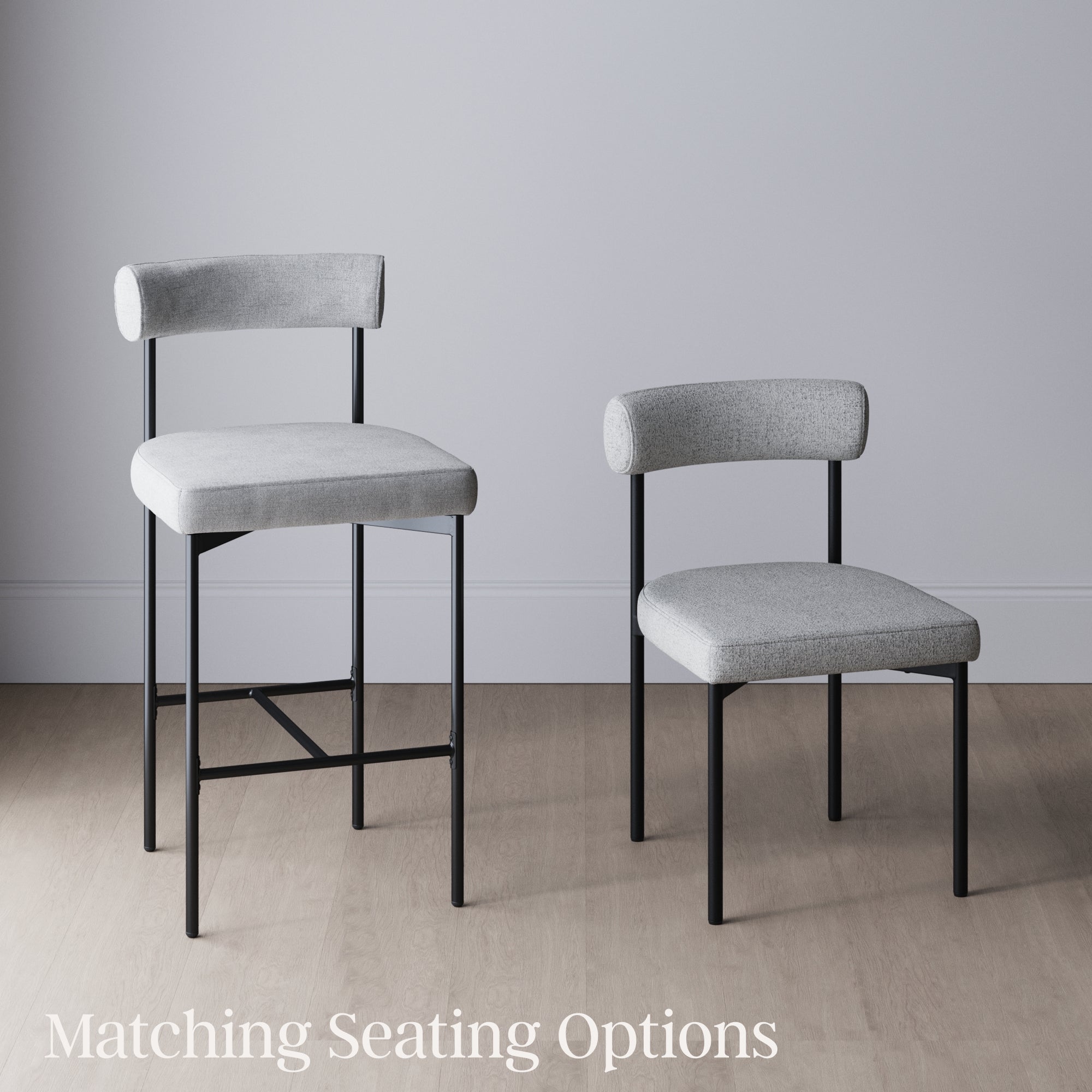 Two modern chairs with light gray upholstered seats and backs and black metal legs, one tall bar stool and one standard chair, are placed side by side on a wood floor against a plain gray wall. Text reads Matching Seating Options.