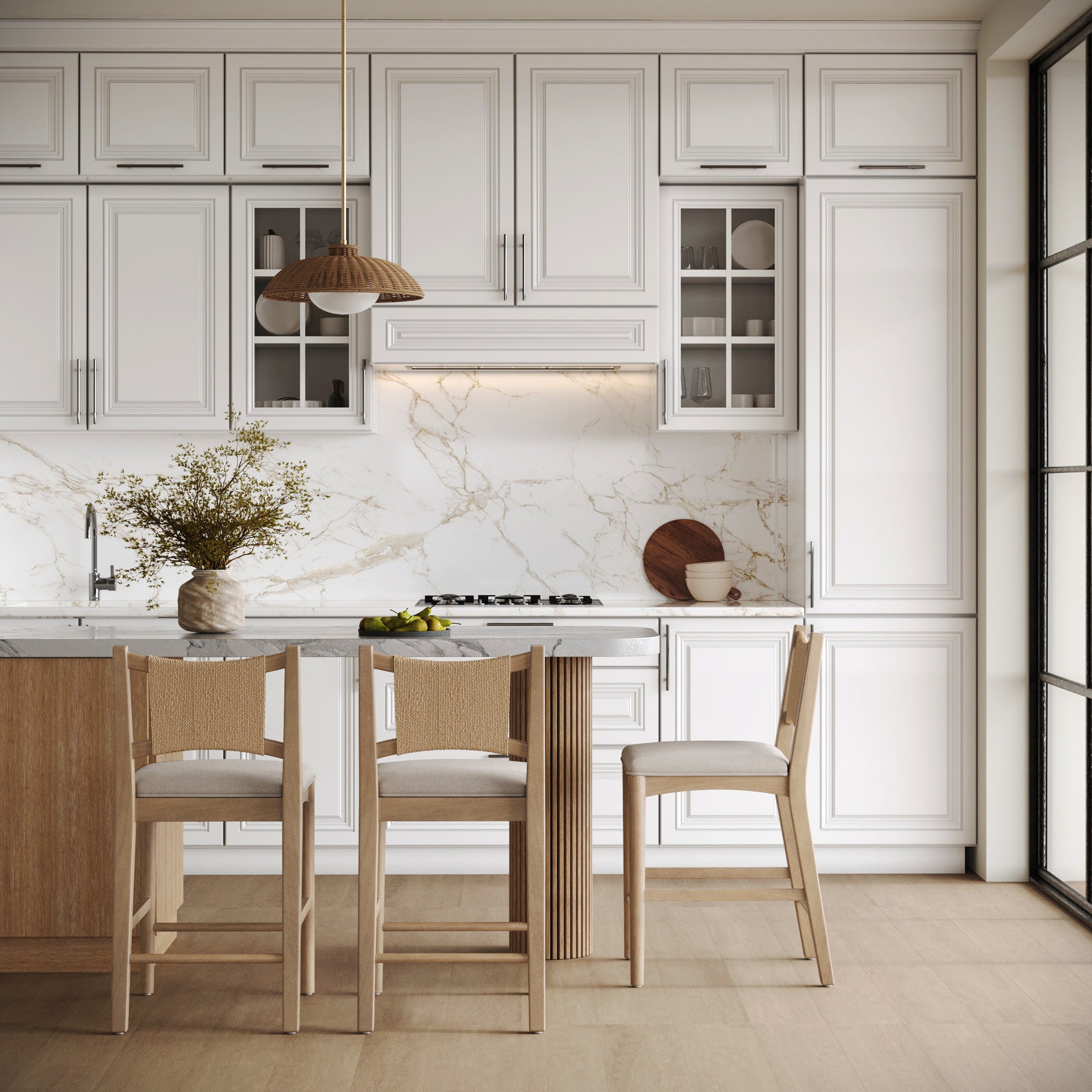 Modern kitchen with white cabinets, marble backsplash, and light wood accents. At the island, a set of three Nathan James Seagrass Back Arched Footrest Counter Height Bar Stools add style; large windows fill the space with natural light.