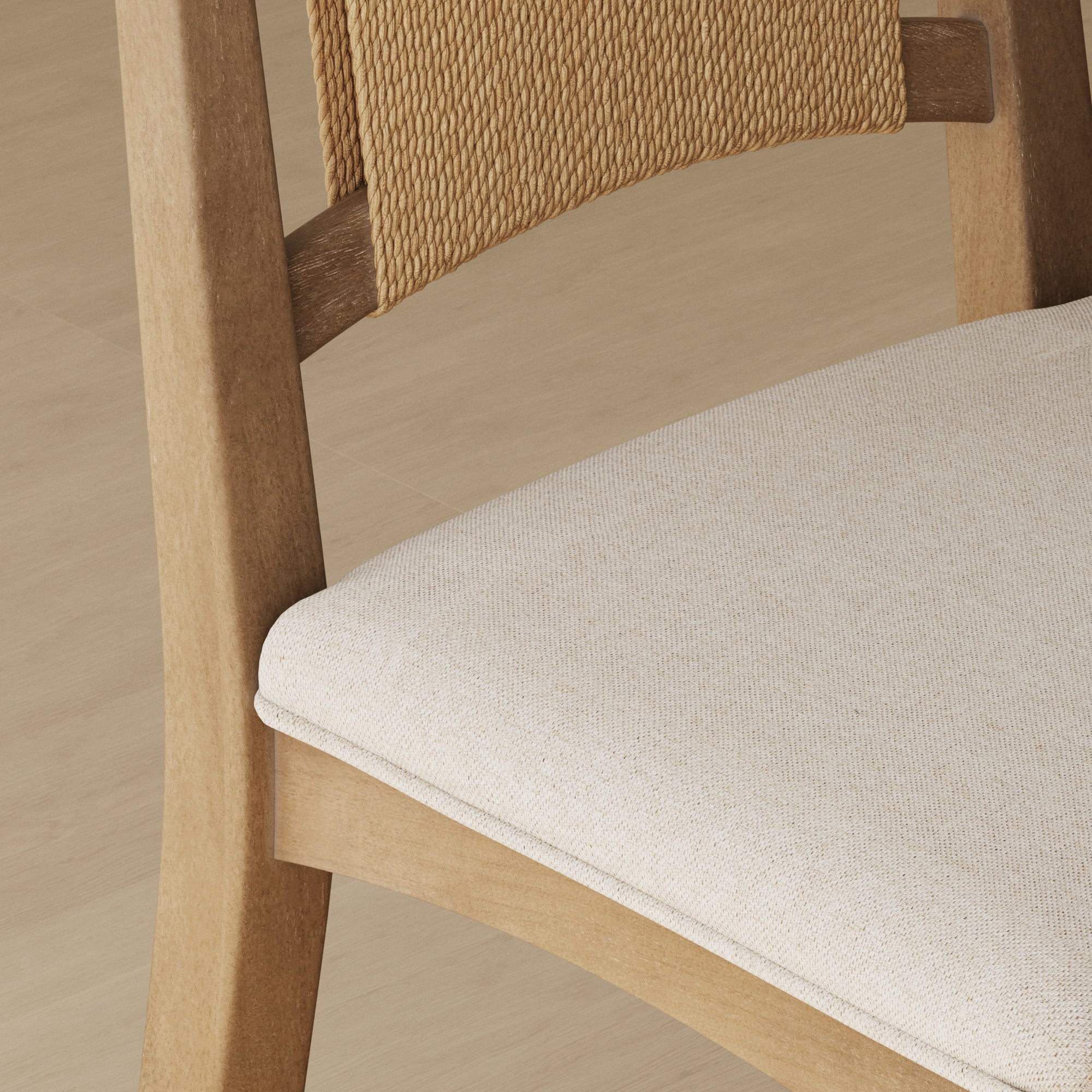 Close-up of a wooden chair featuring a beige upholstered seat and a woven backrest detail, placed on a light wood floor.