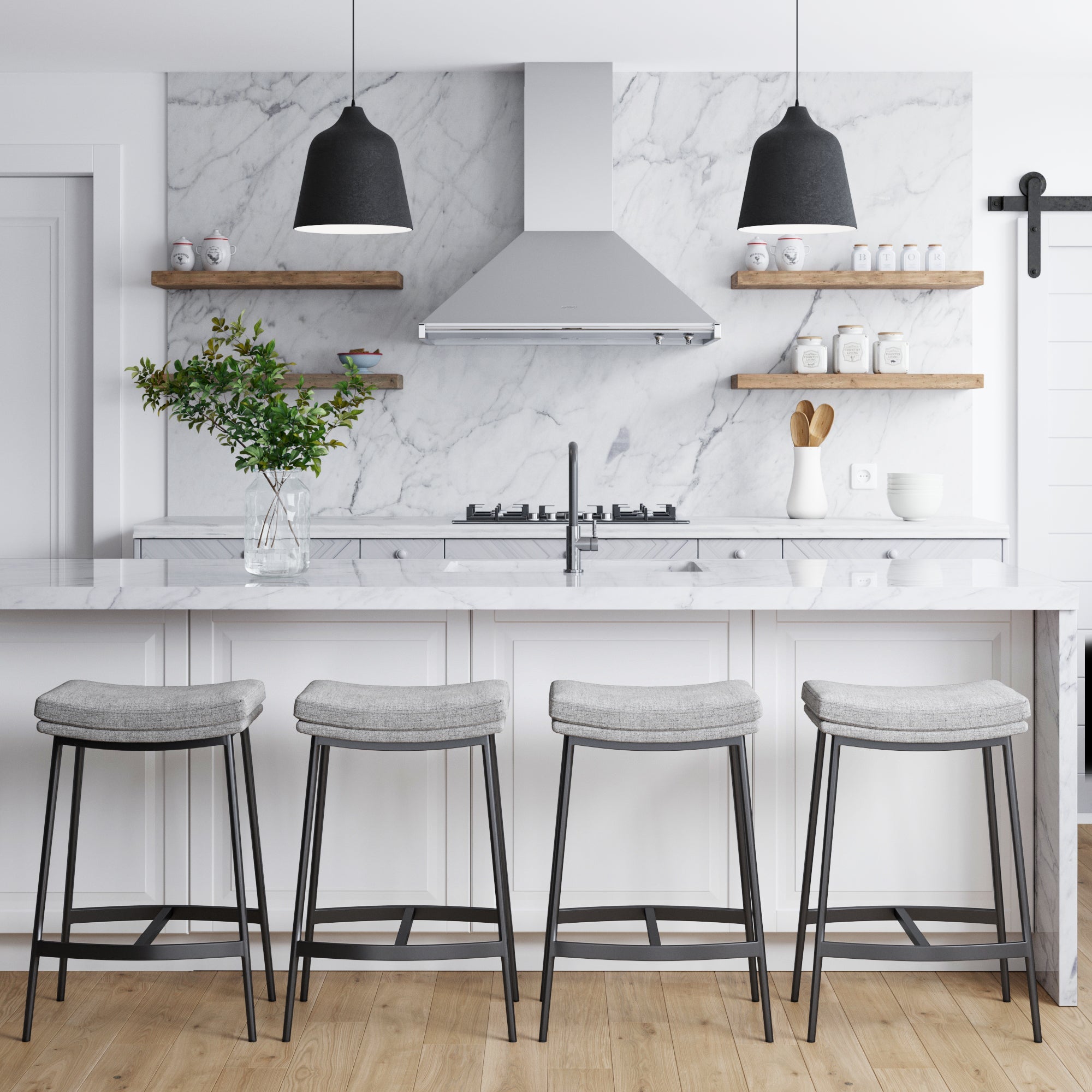 Modern farmhouse kitchen with marble countertops, four Nathan James Upholstered Counter Height Saddle Bar Stools in gray, open wooden shelves with jars and dishes, a stainless steel range hood, pendant lights, and a vase with green branches on the island.