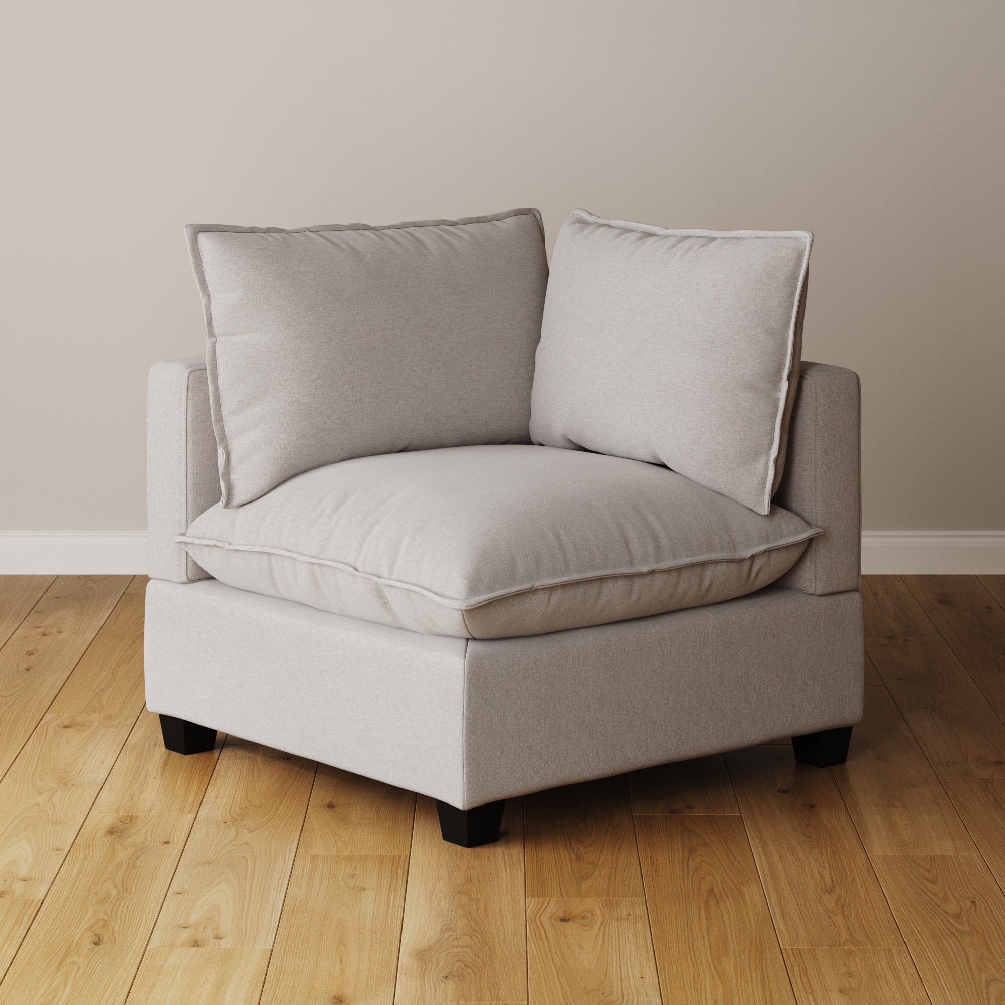 The Nathan James Modern Cloud Sofa Corner Seat in textured gray, featuring deep seat cushions and two large back cushions, sits on a wooden floor against a plain beige wall.