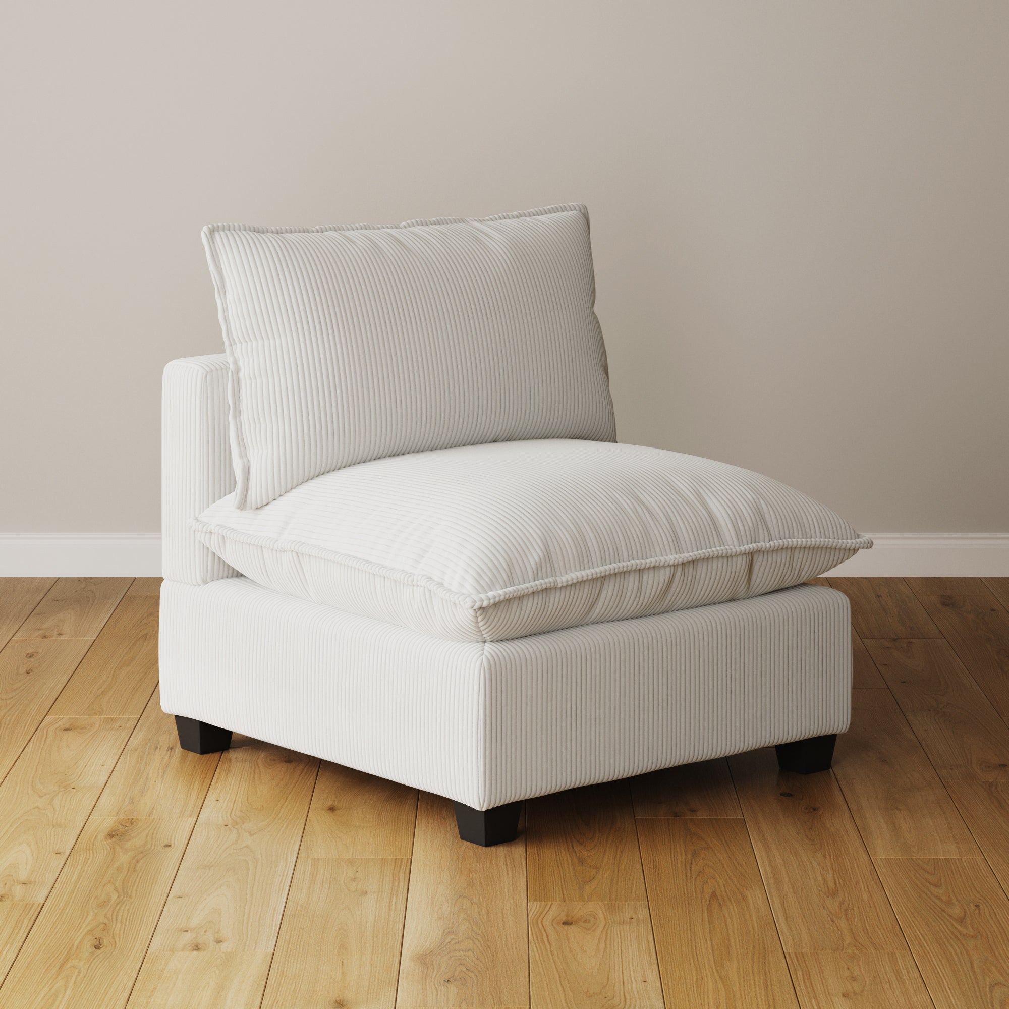 The Nathan James Modern Cloud Sofa Armless Seat in pearl white features a thick cushion and back pillow, subtly striped upholstery, and modular design, evoking a Chelsea Cloud Couch. It sits on a light wood floor against a beige wall.