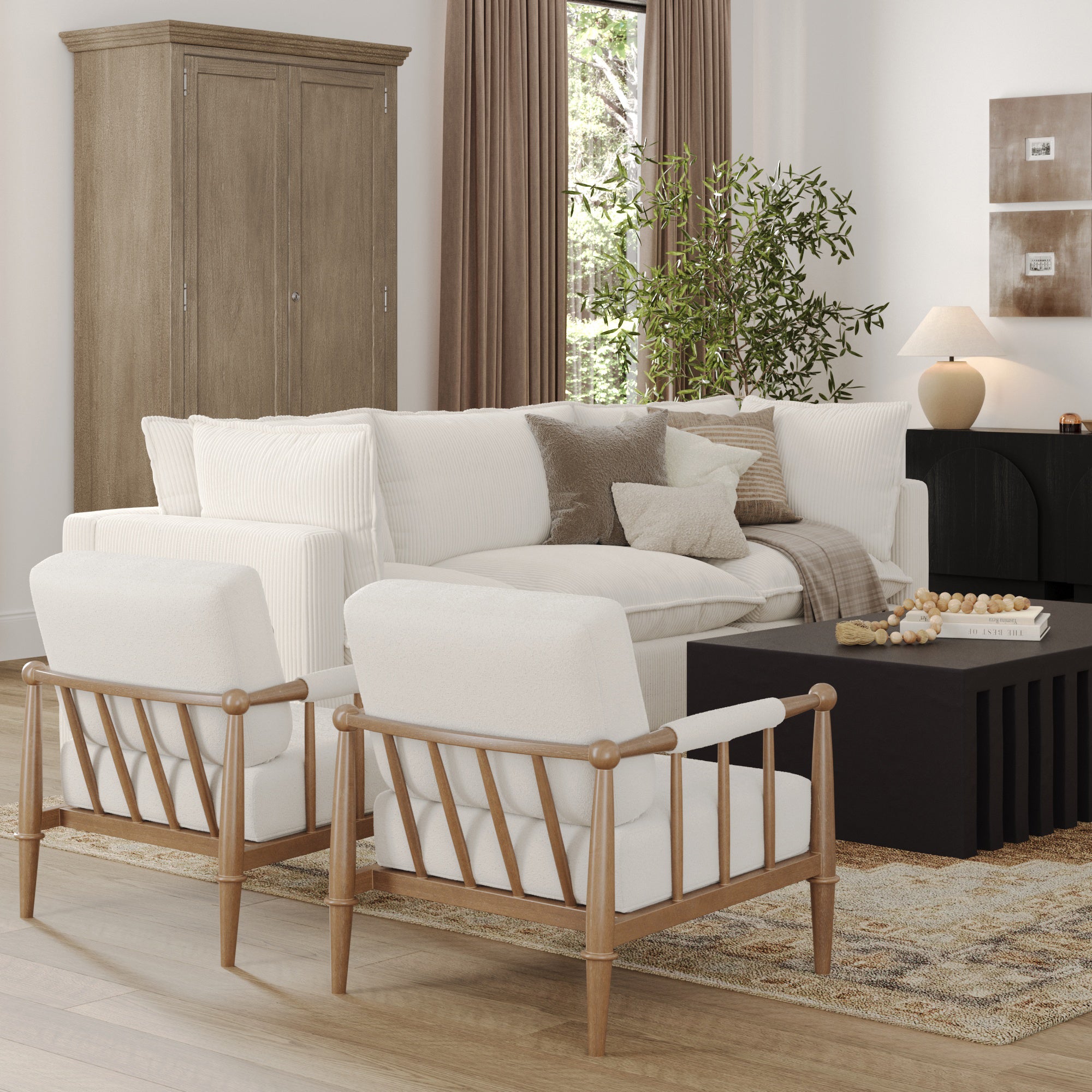 A modern living room with a white sofa, two wooden armchairs, a black coffee table, and neutral decor. There is a tall cabinet, a potted plant, and a window with brown curtains in the background.