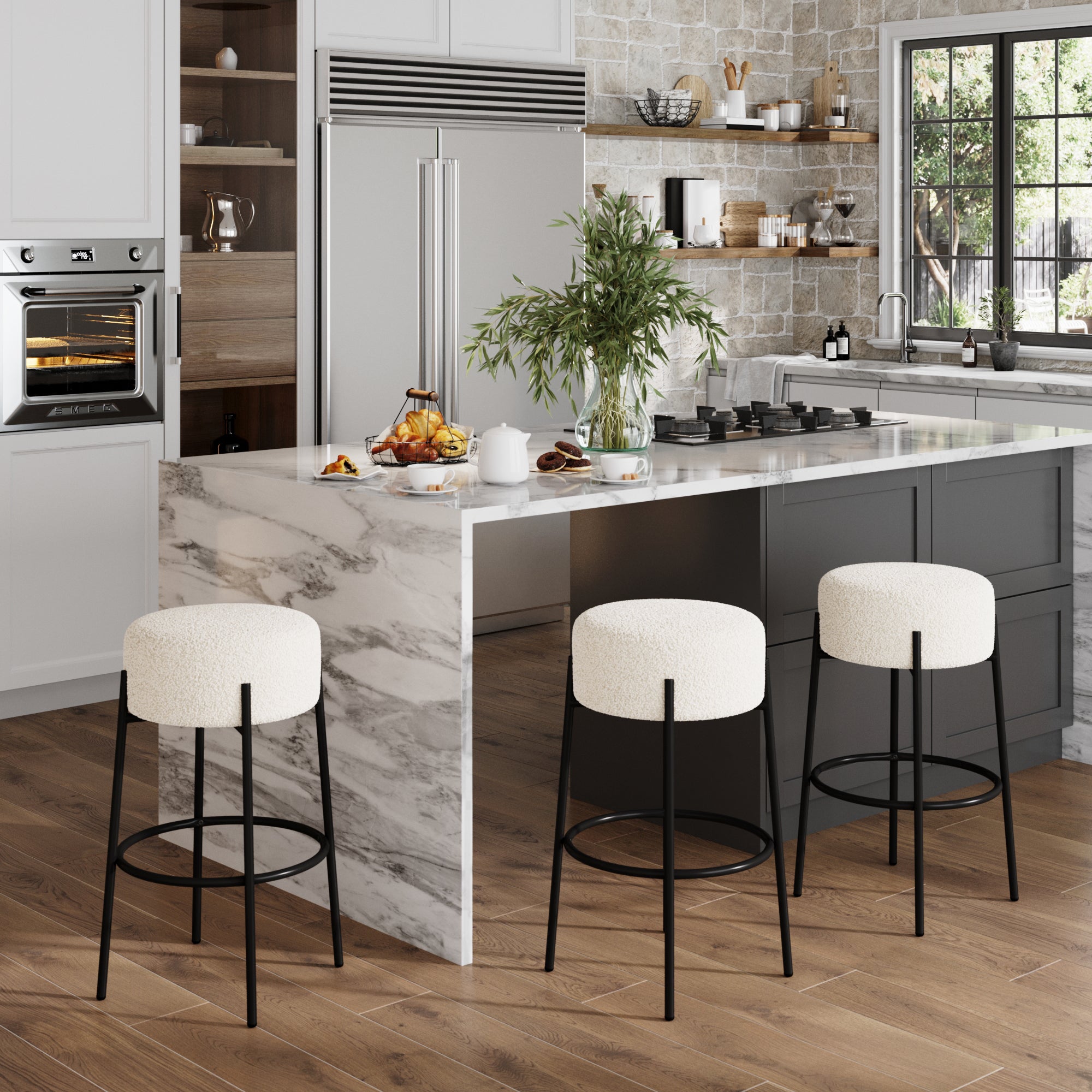 Modern kitchen with a marble island, Nathan James Round Boucle Backless Bar Stools (Set of 3), wooden floor, built-in oven, stainless steel fridge, potted plant on the counter, and a large window letting in natural light.