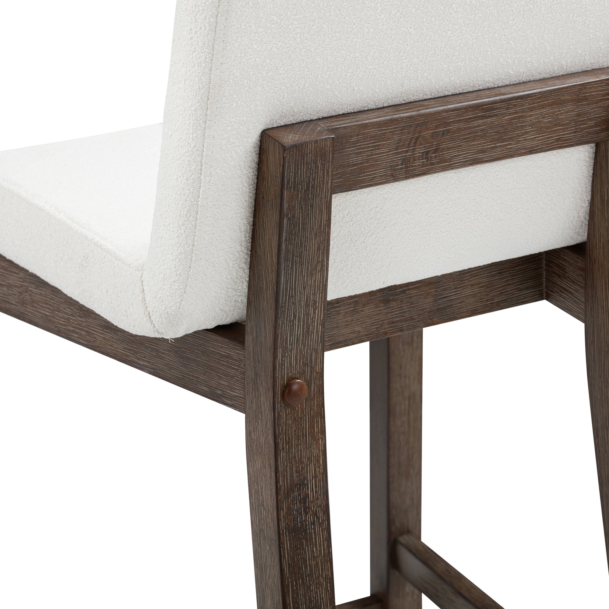 Close-up of a chair showing off-white upholstered seat and backrest, with a wooden frame in a dark brown finish and visible wood grain. The chair has clean, modern lines and sturdy construction.