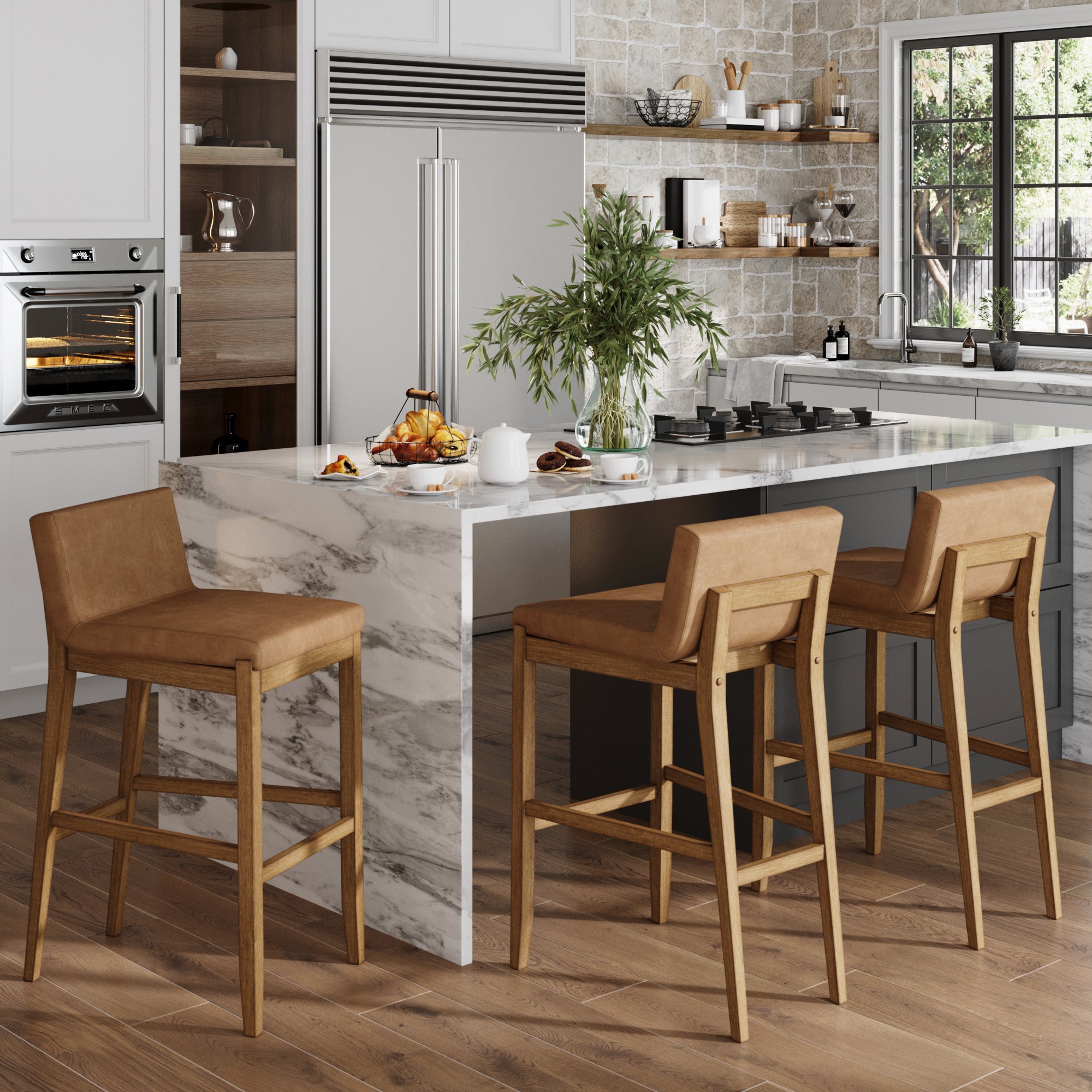 A modern kitchen with a marble island, built-in appliances, and a stone backsplash features three Nathan James Exposed Wood Back Bar Stools in light brown. A large plant and breakfast items sit on the island as sunlight streams through the window above the sink.
