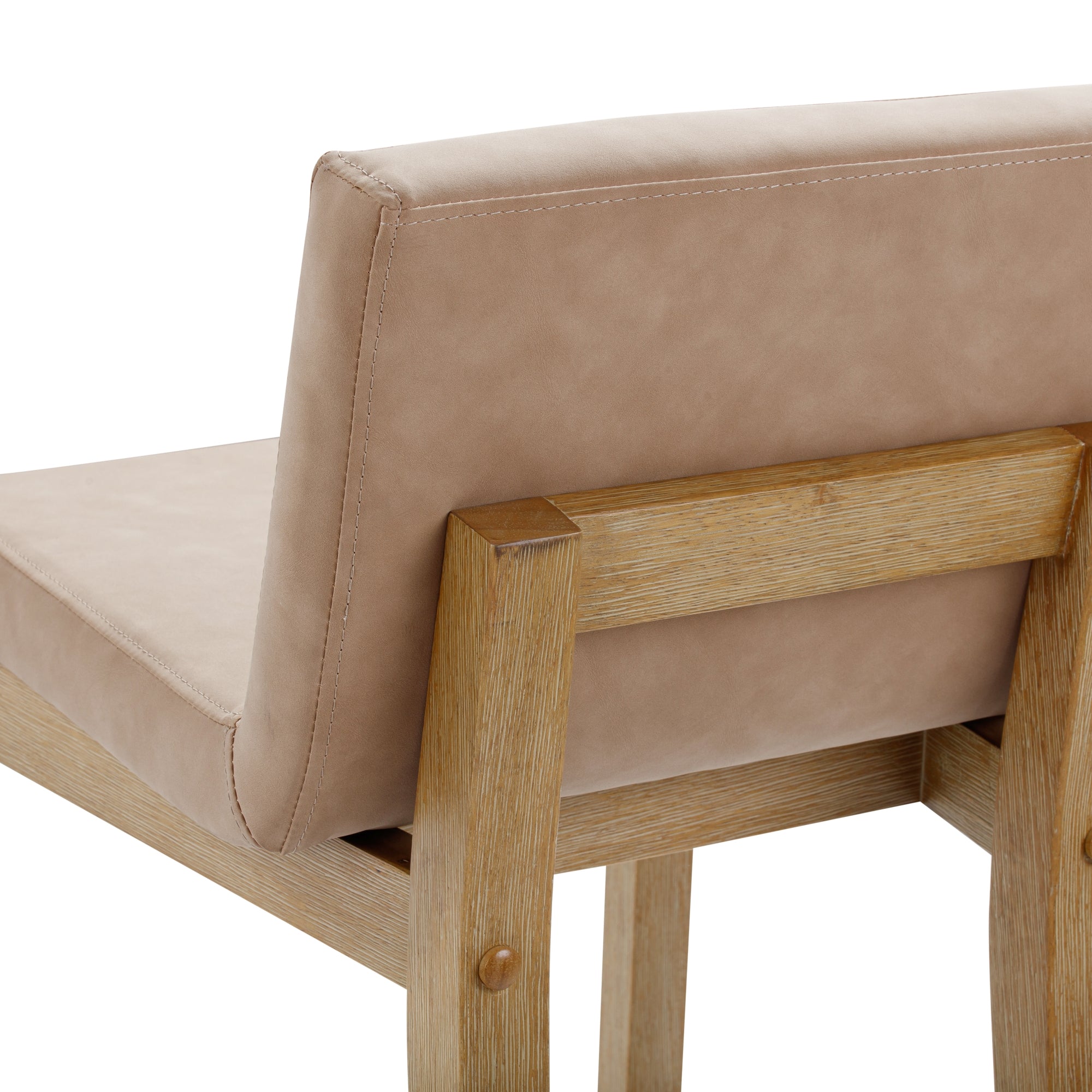 A close-up of a modern chair with light brown leather upholstery and a wooden frame, showing the backrest and part of the seat against a white background.