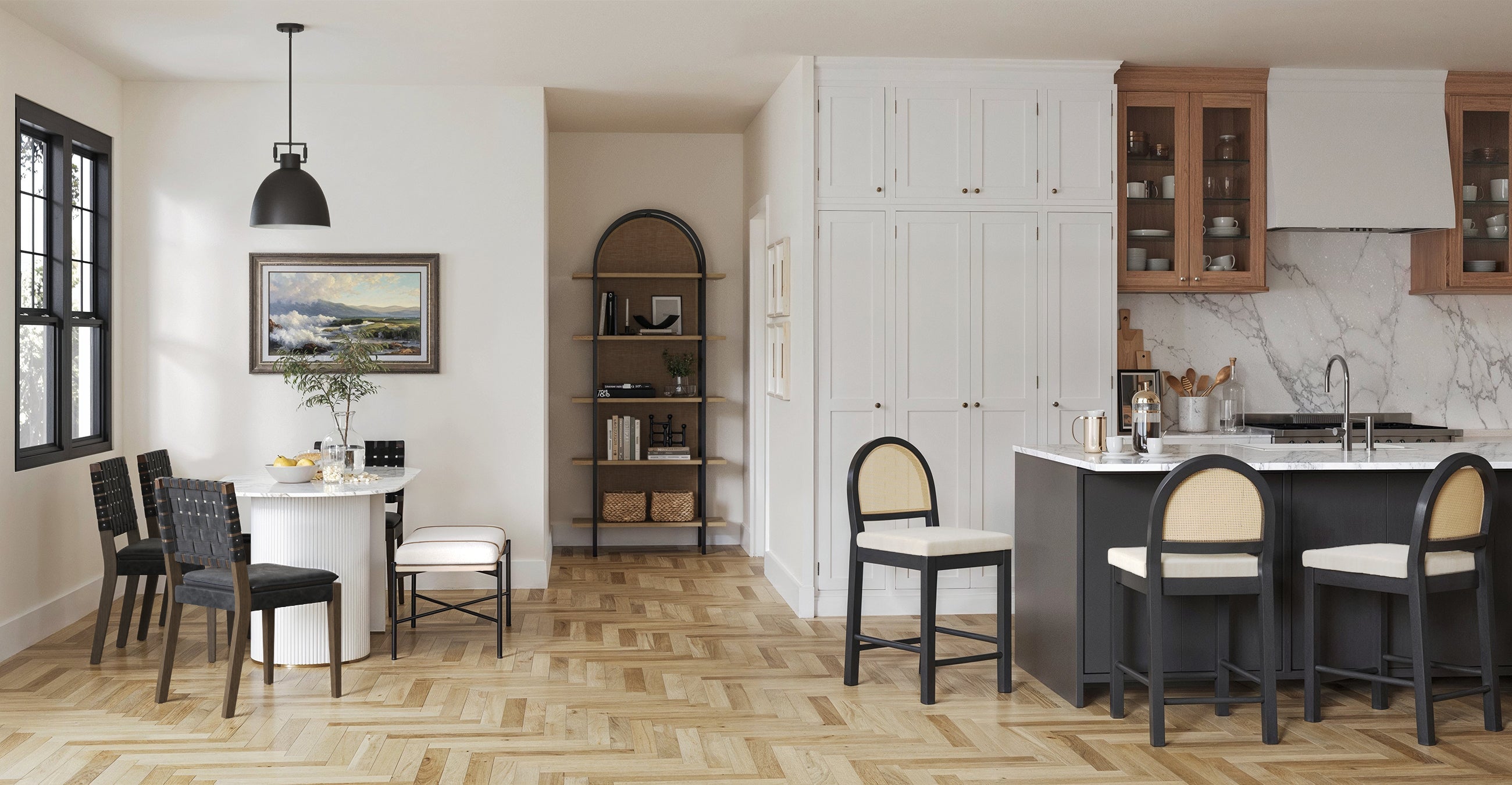 A modern open-concept kitchen and dining area with herringbone wood floors, a round white dining table, black chairs, a marble kitchen island with stools, white cabinetry, and wall art above the table.