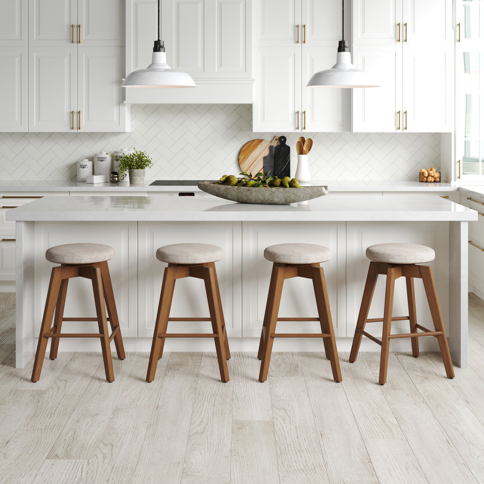 Bright modern kitchen with white cabinets, a marble island, pendant lights, and four Nathan James Wood Swivel Counter Height Bar Stools (Brown) surrounding a centerpiece bowl of limes on the counter.