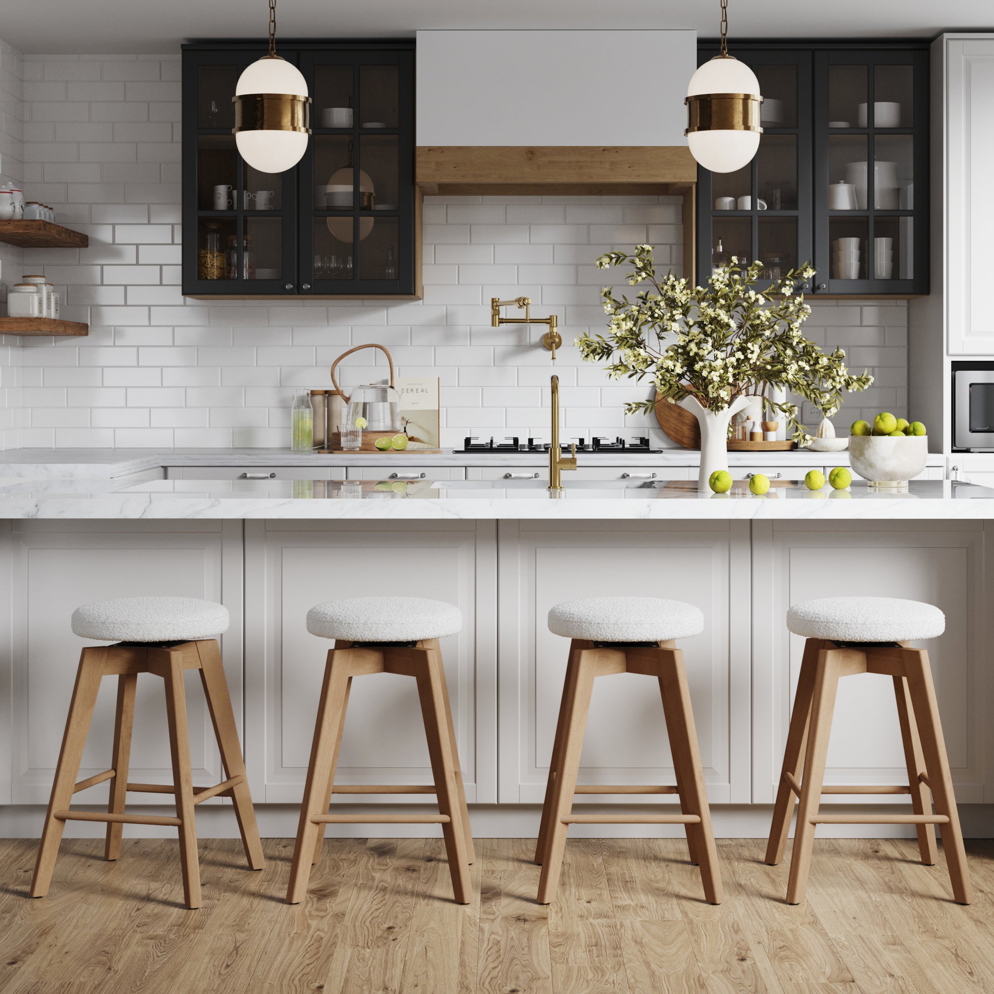 Modern kitchen with a white island, marble countertop, gold fixtures, subway tile backsplash, glass-front cabinets, pendant lights, and a vase with white flowers. Features four Nathan James Wood Boucle Swivel Counter Stools in White Oak.