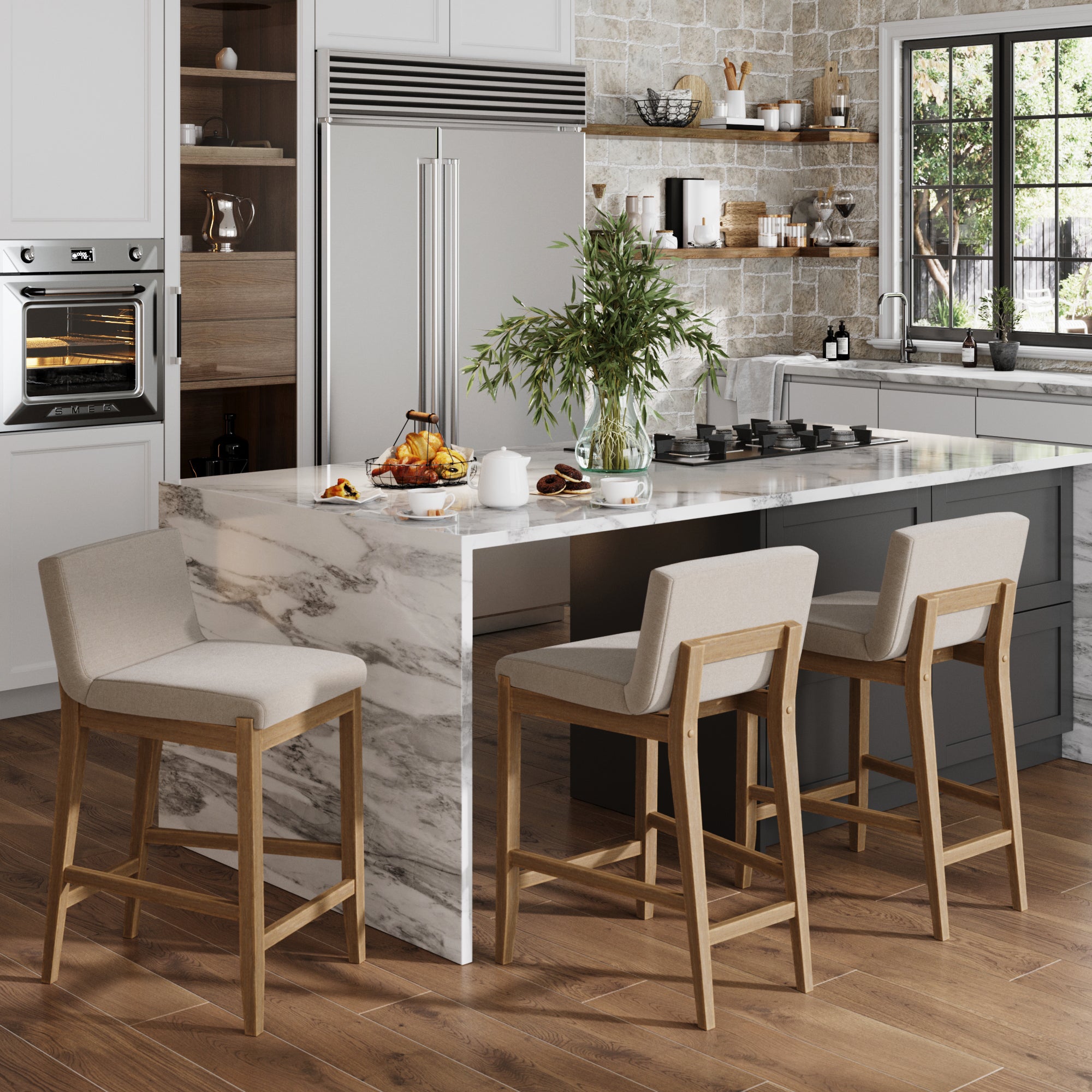 Modern kitchen with a marble island, set of 3 Nathan James Wood Counter Height Bar Stools in light brown, built-in oven, stainless steel fridge, wooden floor, and a sunny window. A plant and breakfast items on the island complete the modern look.