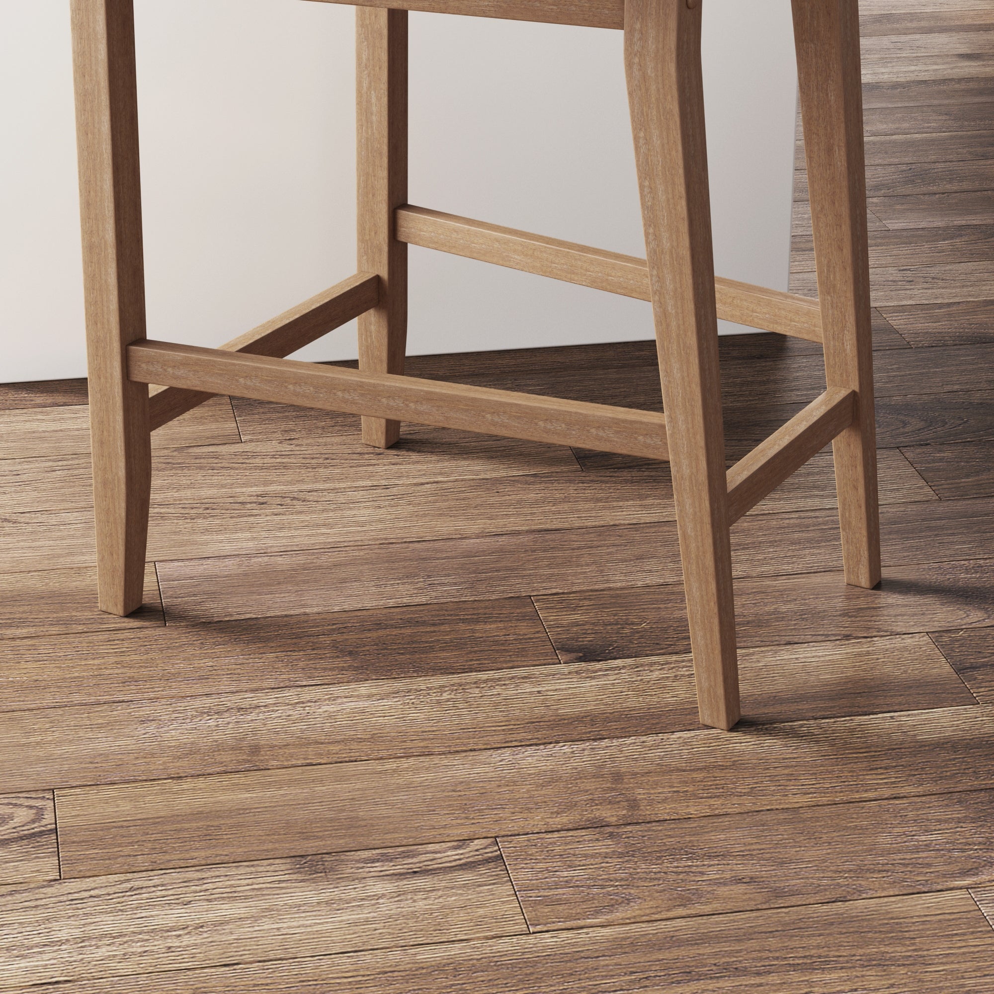 Close-up of the legs of a wooden chair or stool on a floor with wood grain texture. The light brown furniture and flooring have a natural, rustic appearance. The image focuses on the lower portion of the chair and the floor.