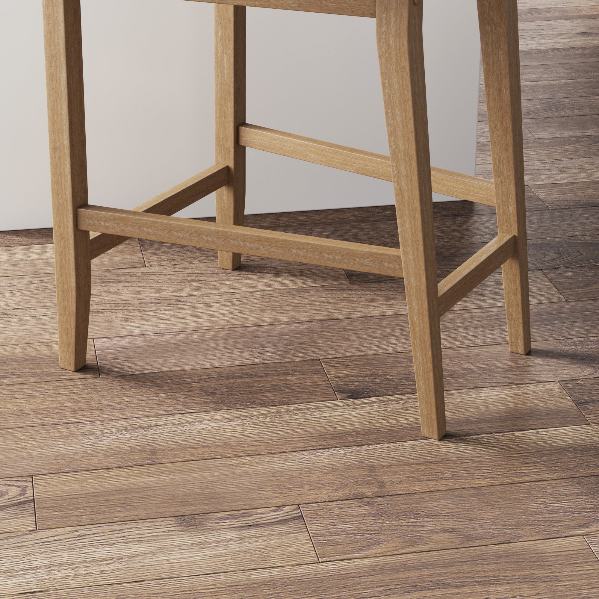 Close-up of the legs of a wooden chair on a floor with matching wooden planks. The wood grains and textures of both the chair and the floor are clearly visible.