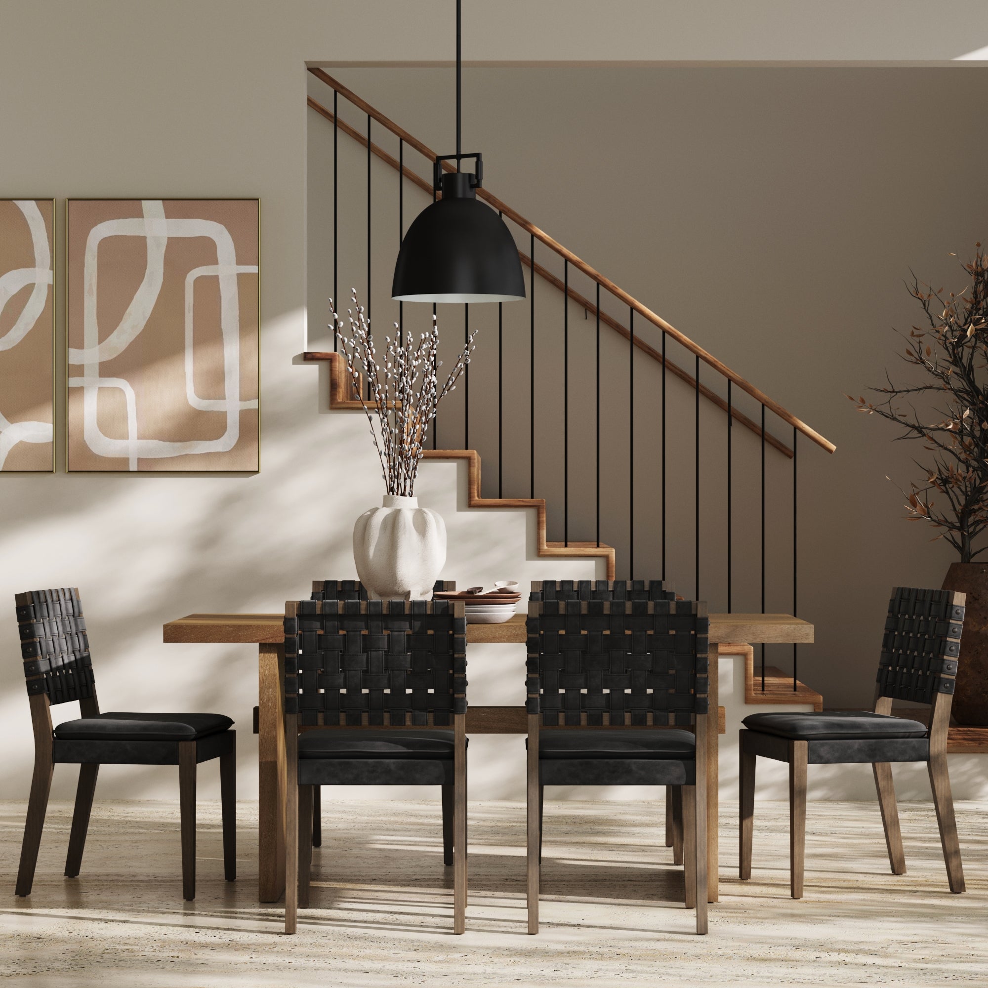 A modern dining room with a wooden table, six Nathan James Faux Leather Dining Chairs Black, a large white vase with branches, abstract wall art, a staircase with a wooden handrail, and a black pendant light overhead.
