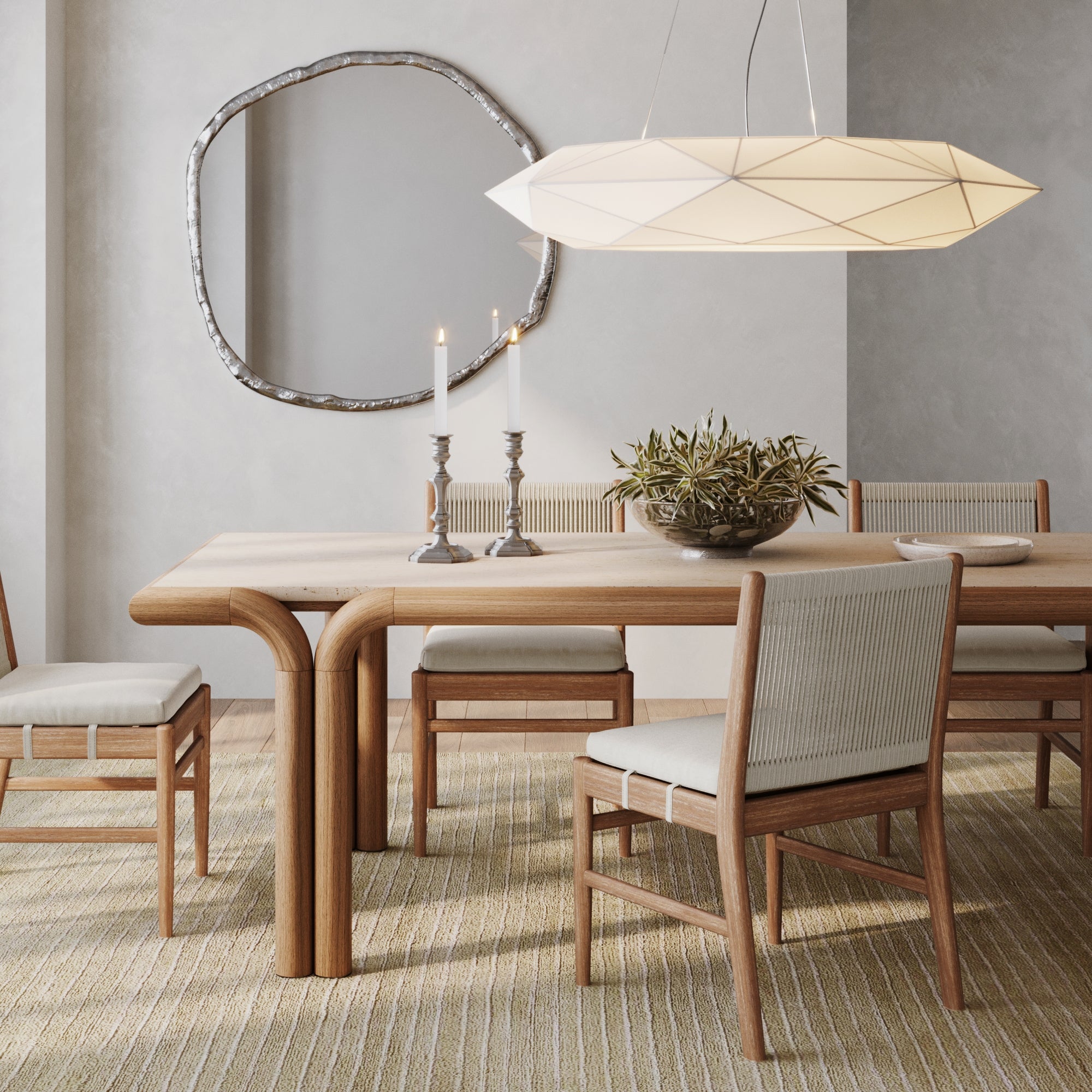 A modern dining room with a light wood table, six Nathan James Woven Rope Back Dining Chairs in brushed light brown, beige upholstered cushions, a geometric white pendant light, candles, plant centerpiece, large mirror, and textured beige rug.