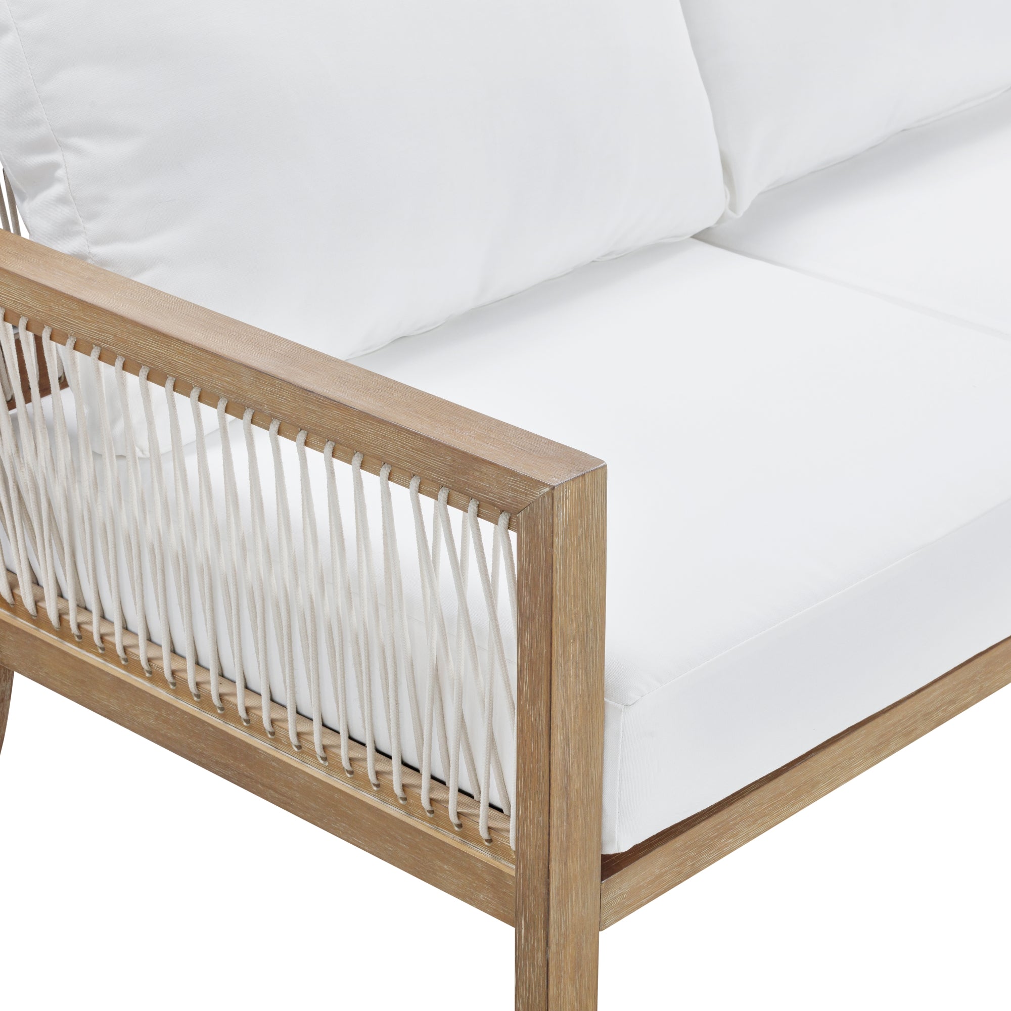 Close-up of a modern outdoor sofa with a light wood frame, white cushions, and white woven rope detailing along the side.