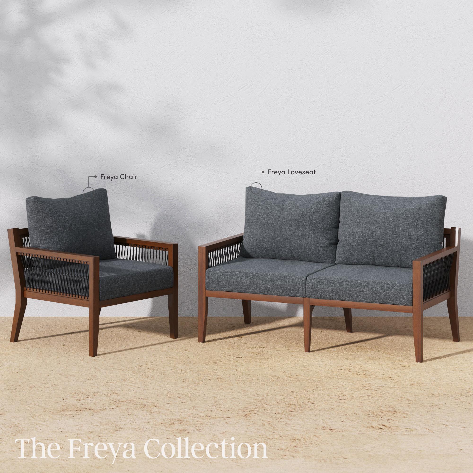 A wooden-framed Freya chair and a Freya loveseat with dark gray cushions are displayed outdoors against a white wall on a light textured surface. Text labels identify each piece. The Freya Collection is written at the bottom.