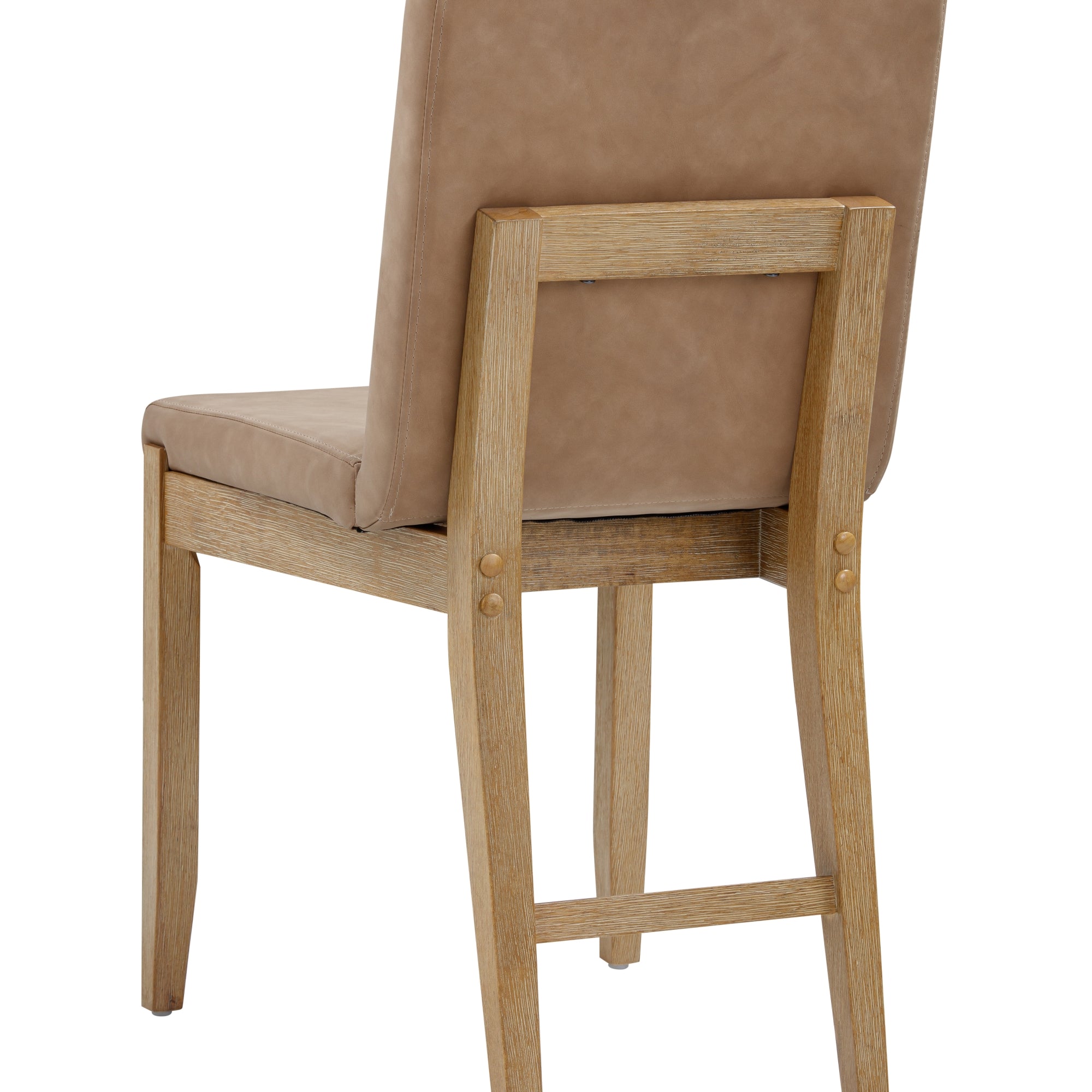 A wooden chair with a light brown padded seat and backrest, viewed from behind at an angle. The frame is made of light-colored wood with simple, clean lines and visible joints.