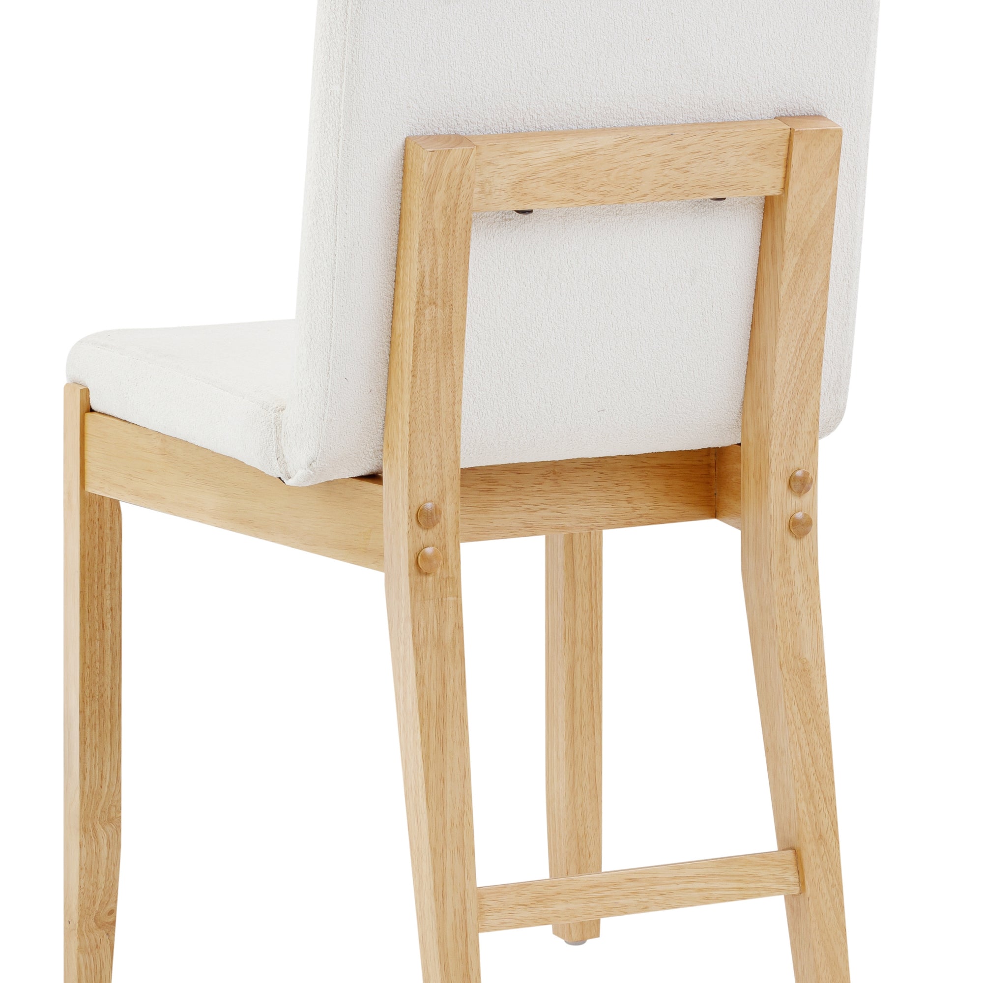 A close-up view of the back and legs of a wooden chair with a light-colored cushioned seat and backrest. The wood has a natural finish, and the design is simple and modern.