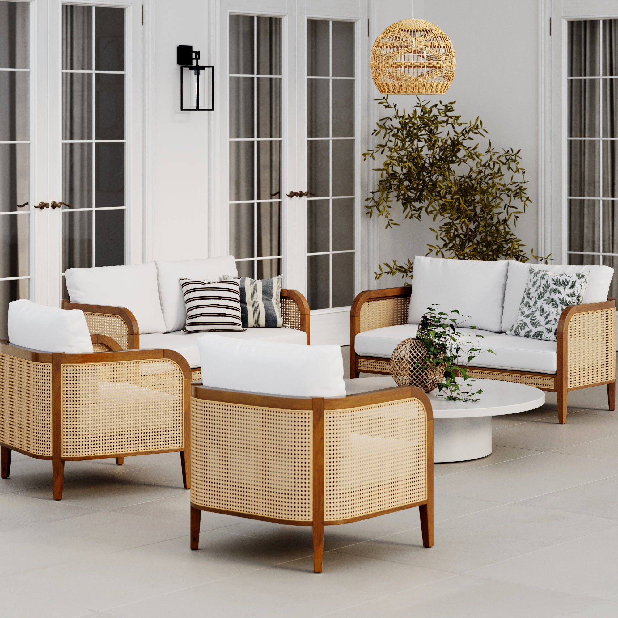 The modern, inviting patio showcases the Nathan James Outdoor 4 Piece Wood Patio Set with rattan loveseats and chairs, a round coffee table, potted plant, hanging wicker lamp, large glass doors, and removable washable cushion covers.