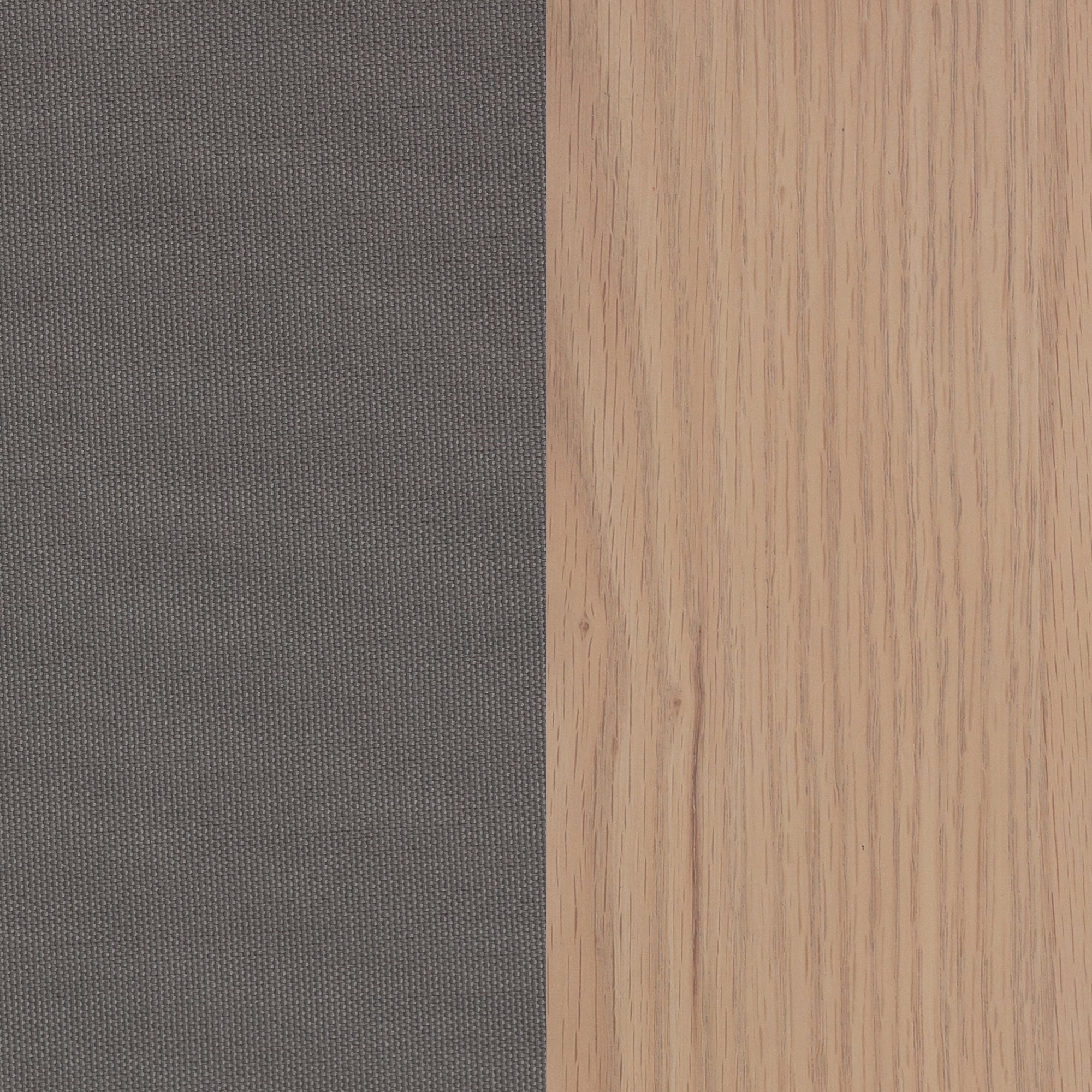 A close-up view of two contrasting surfaces: a dark gray textured fabric on the left and light wood grain on the right, divided vertically down the center.