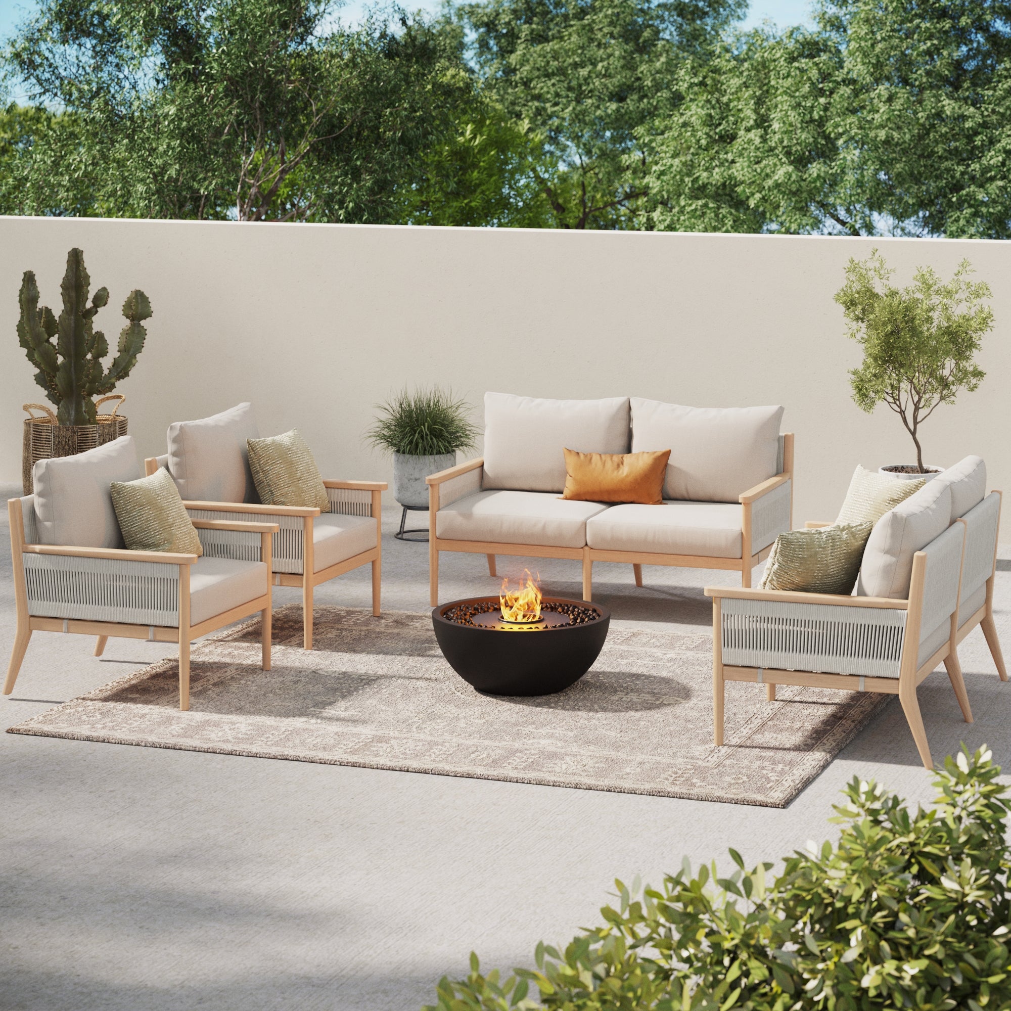 Relax in your outdoor space with the Nathan James Outdoor 4 Piece Wood Patio Set Loveseats and Chairs White, featuring weatherproof acacia wood, beige cushions with removable covers, a fire pit, and potted plants on a rug under blue skies.