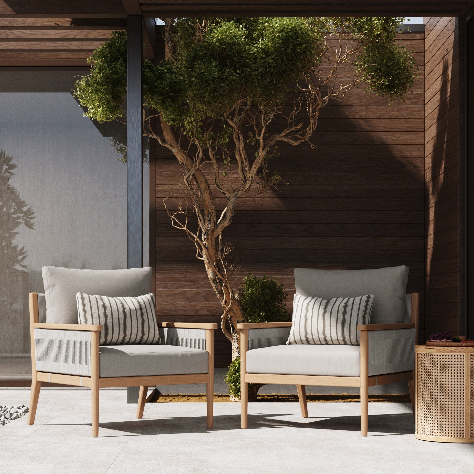 The Nathan James Outdoor Wood & Rope Patio Arm Chairs in Ash White (Set of 2) feature weatherproof acacia wood, light washable cushion covers, and striped pillows, perfect for patios or gardens.