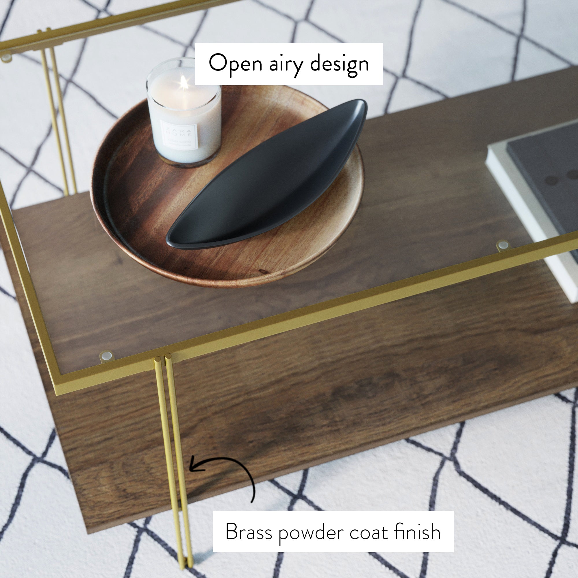 Glass coffee table with brass powder-coated frame and wooden shelf, decorated with a candle and black dish on a wooden tray. Labels highlight the open airy design and brass finish. Geometric rug underneath.