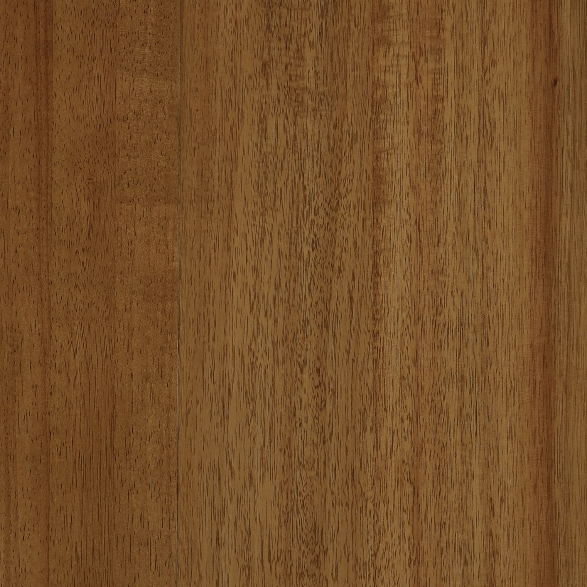 A close-up view of a wooden surface with a natural grain pattern and a warm brown color. The wood texture shows subtle variations in tone and fine lines running vertically.
