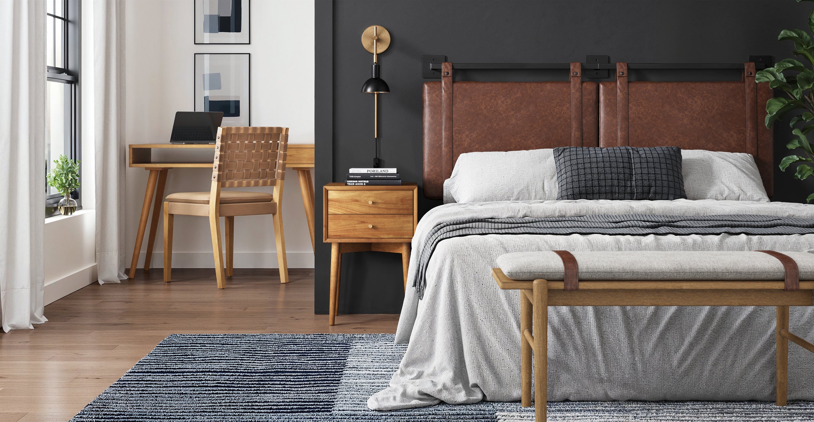 A modern bedroom with a leather headboard, neatly made bed, wooden bench, bedside table, desk with a chair, rug, and wall art; a window with white curtains lets in natural light.