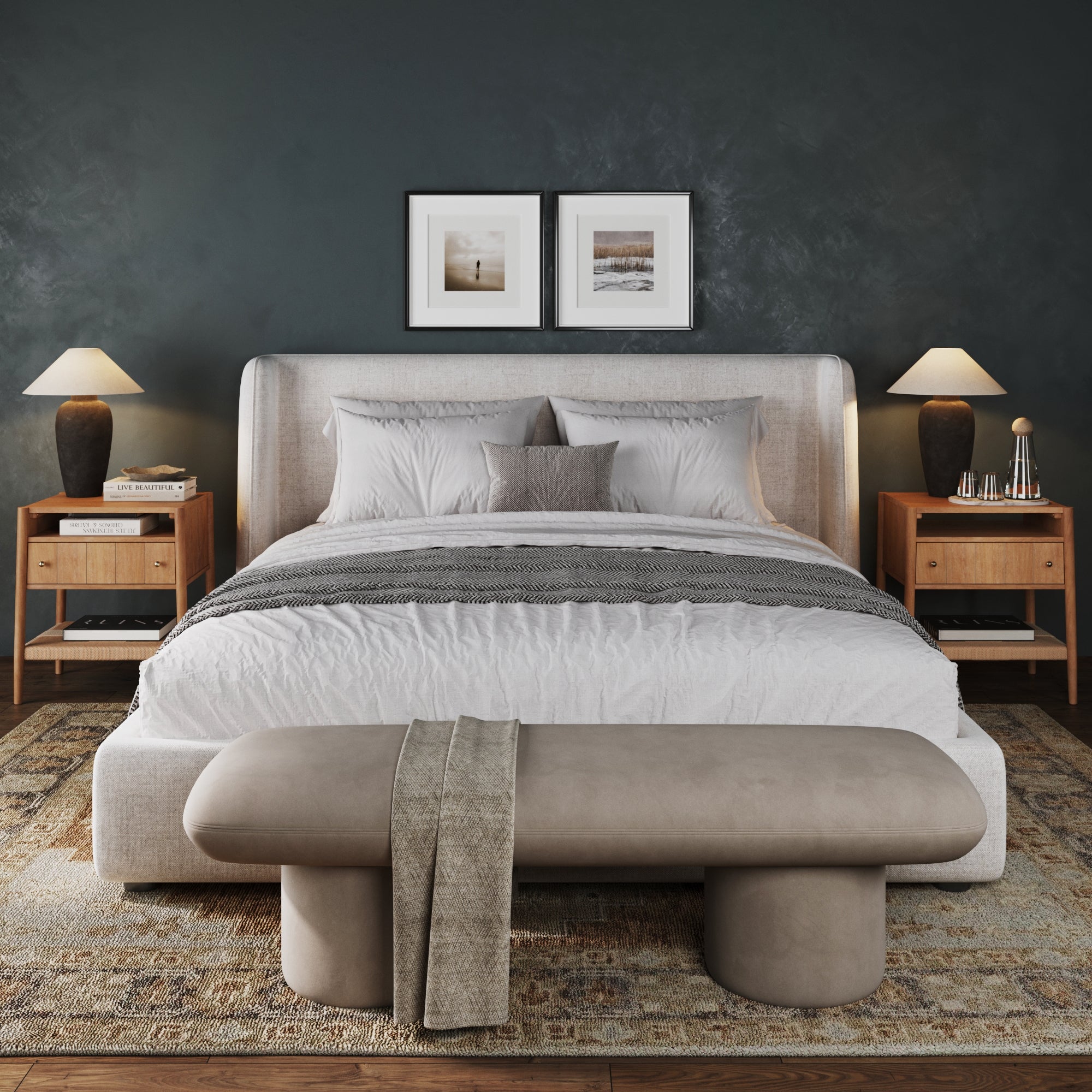 A modern bedroom includes a large bed with neutral bedding, two Nathan James Wood Nightstands with Drawer & Seagrass Storage in light brown, lamps, a beige bench at the foot, and framed art on a dark accent wall above the bed.