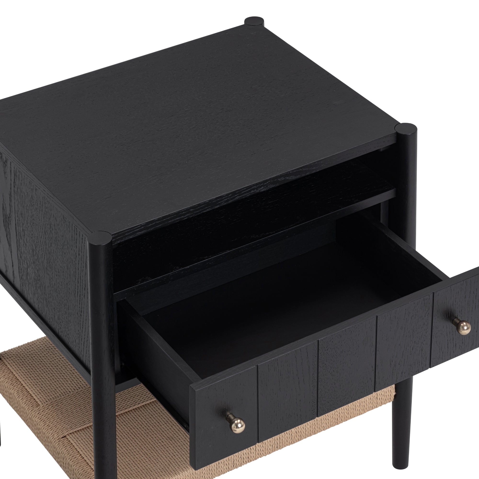 A black wooden nightstand with an open drawer and an open shelf above it, featuring round metal knobs and a woven lower shelf.