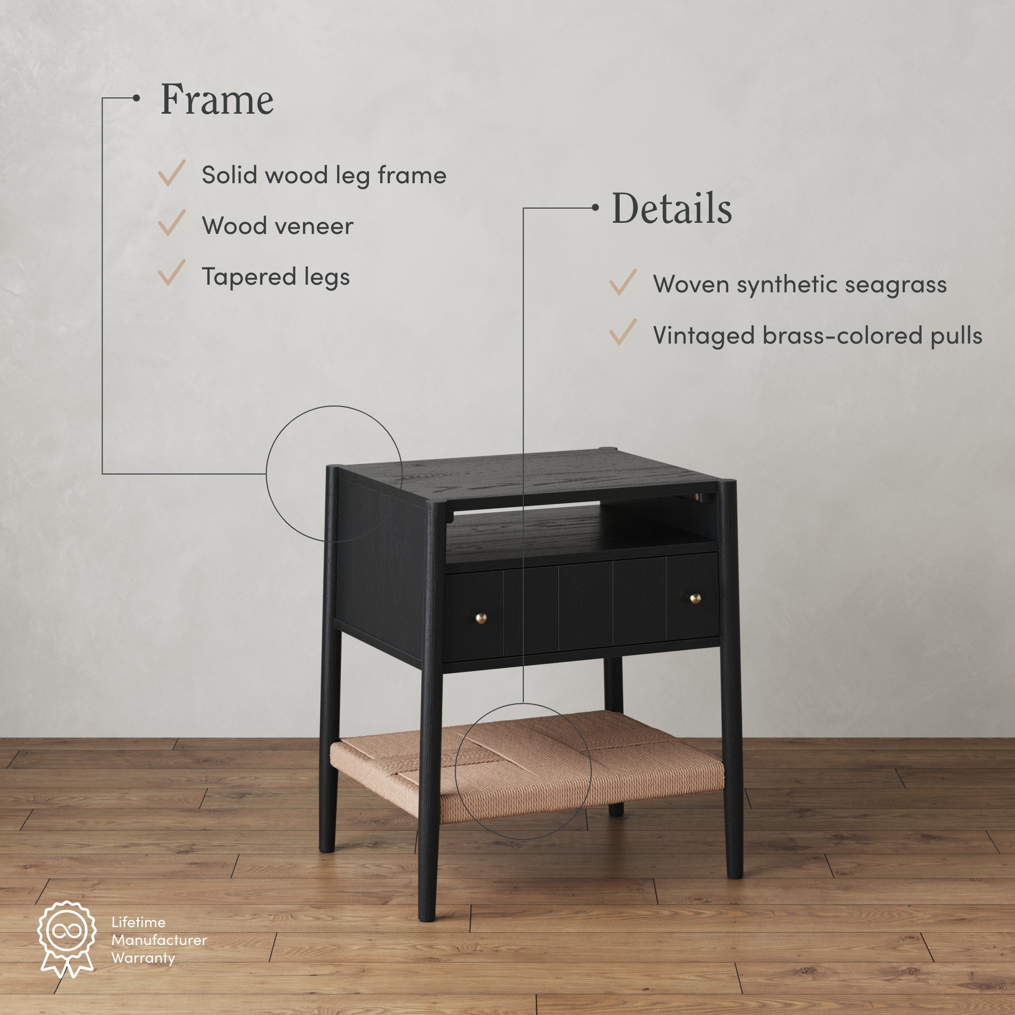A black wooden nightstand with a shelf made of woven synthetic seagrass and brass-colored pulls sits on a wood floor. Text highlights its solid wood leg frame, wood veneer, tapered legs, and featured materials.