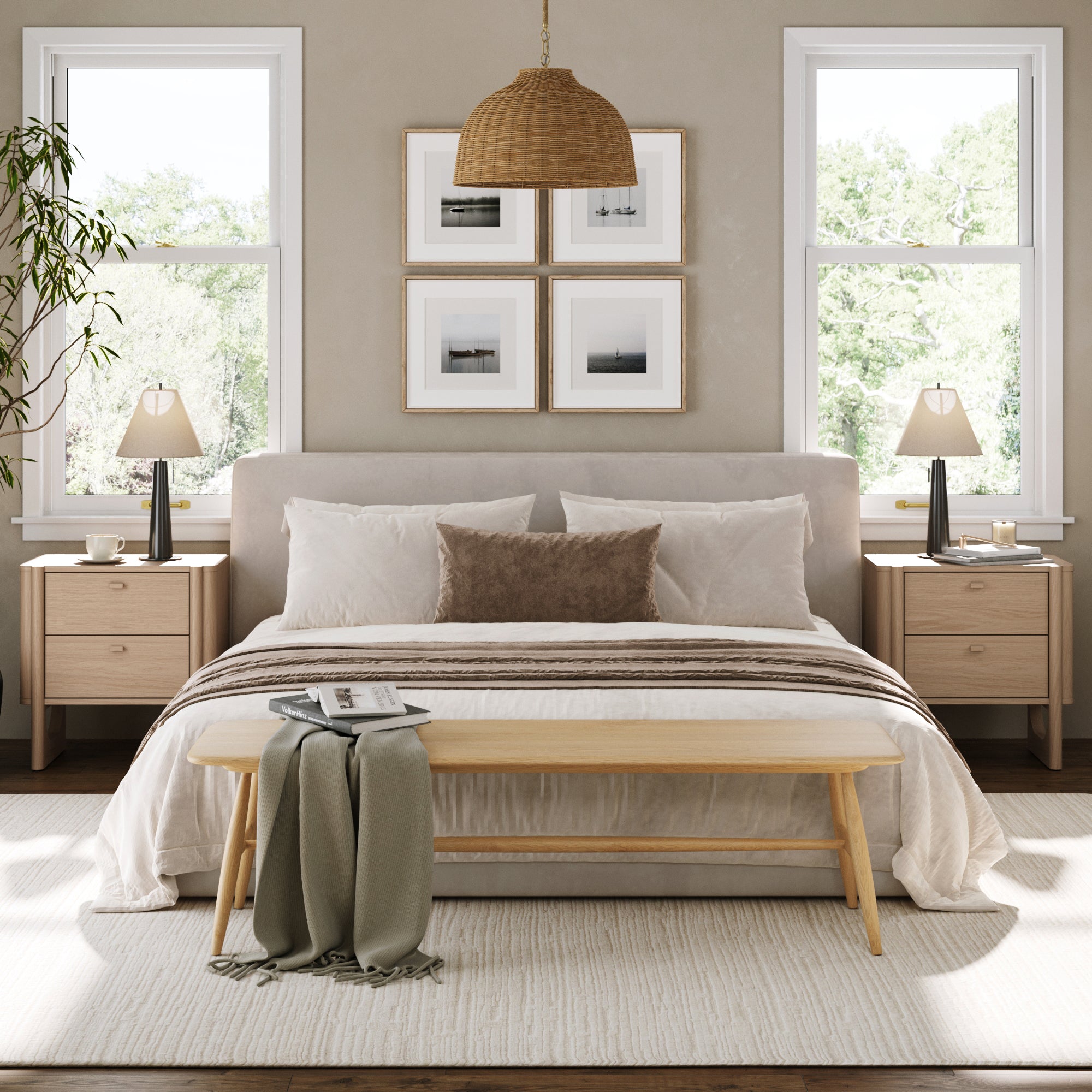 A cozy, modern bedroom with a neutral palette features a bed with white linens and a brown pillow, Nathan James Mid Century Modern 2-Drawer Solid Wood Nightstands in Raw Oak, lamps, framed art, woven pendant light, and a bench with a green throw at the foot.