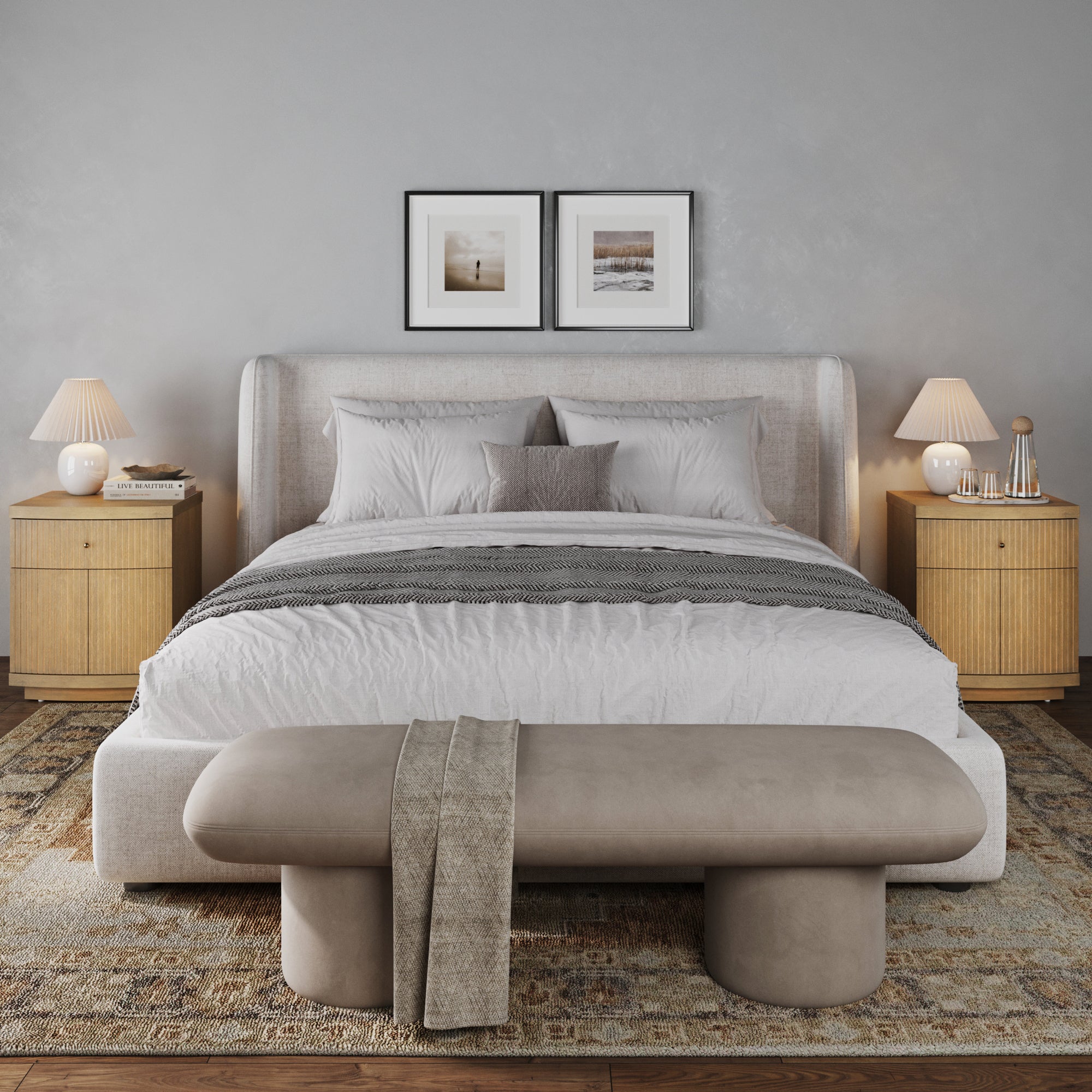 A modern bedroom with a neatly made bed, a padded bench, framed art above the headboard, and two Nathan James Fluted Nightstands with Drawer and Cabinet Storage in light brown, all in a soft, minimalist mid-century style.
